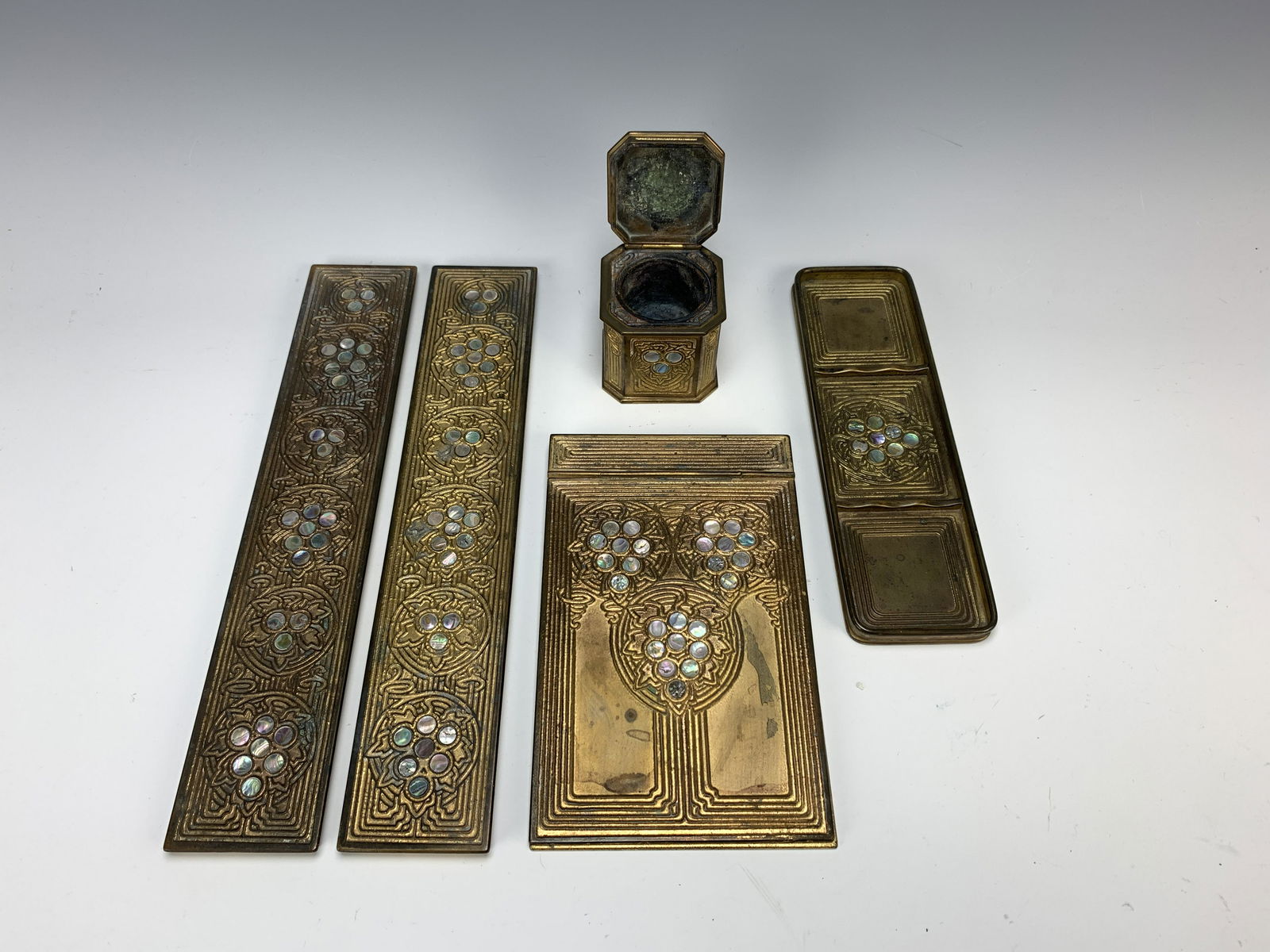Tiffany Studios Bronze Abalone Desk Set: 5 piece Tiffany desk set in the Abalone pattern consisting of an inkwell, a pen tray, a pair of blotter ends and a notepad holder, each signed "Tiffany Studios, New York" and numbered 1148, 1158, 1153