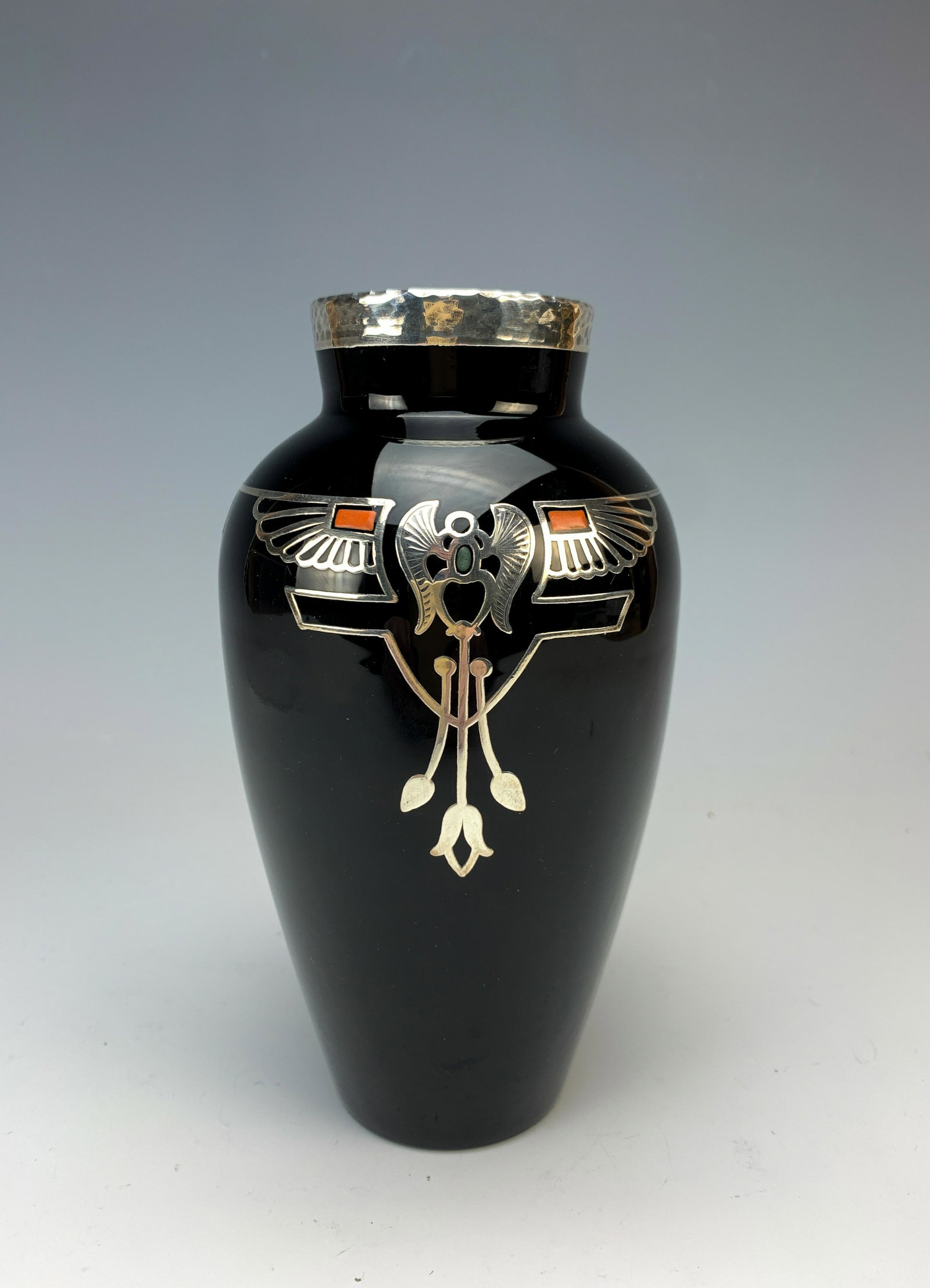Rockwell Black Vase With Sterling Silver Overlay: This vase measures 6 1/4" high x 3 1/2" at the shoulder and weighs 265 grams. It has an enamel & sterling silver Egyptian design on both sides and is marked faintly (upside down) on the rim with the w