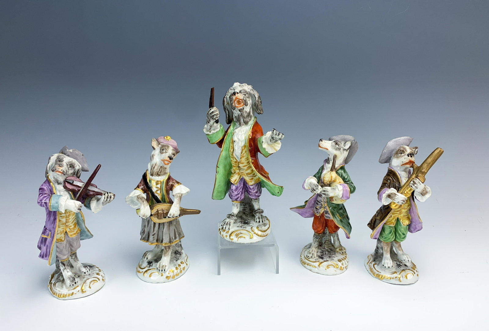 5 Piece German Porcelain Dog Band W/crossed Swords: Circa 1930's. Charming dog band made of porcelain, has blue underglaze crossed swords marks. Size: 5.5" tallest. Condition: Band leader has broken fingers on one hand and his baton broken. Bagpiper ha