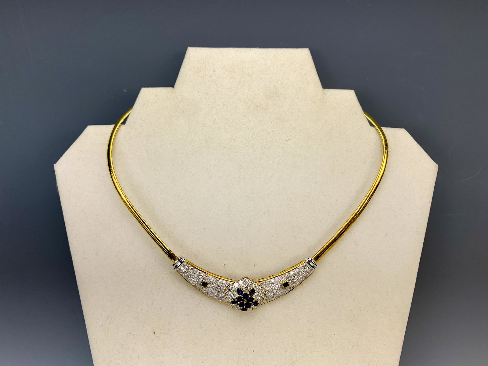 Retro 14k YG Diamond And Sapphire Necklace +7 cts diamonds: Having a beautiful ladies 14K yellow gold omega necklace made in Italy with diamonds and small cluster of sapphires in the center and either side a small square sapphire amongst diamonds w/box. 7.21ct