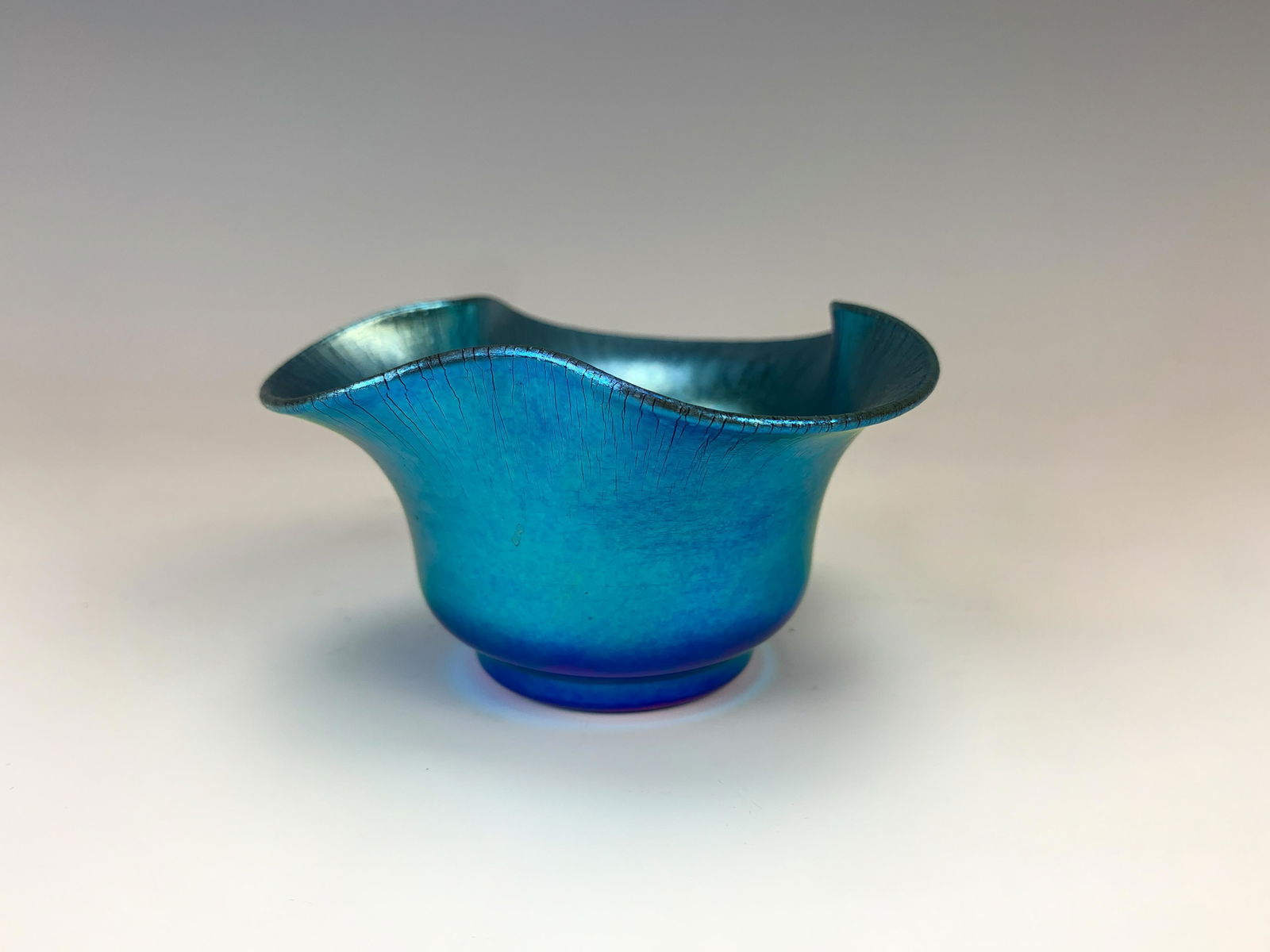 Signed Steuben Blue Aurene Small Glass Bowl: Small scalloped blue Aurene bowl signed "Aurene 740." Size: 1.75" tall x 3 7/8" widest. Condition: Very good.