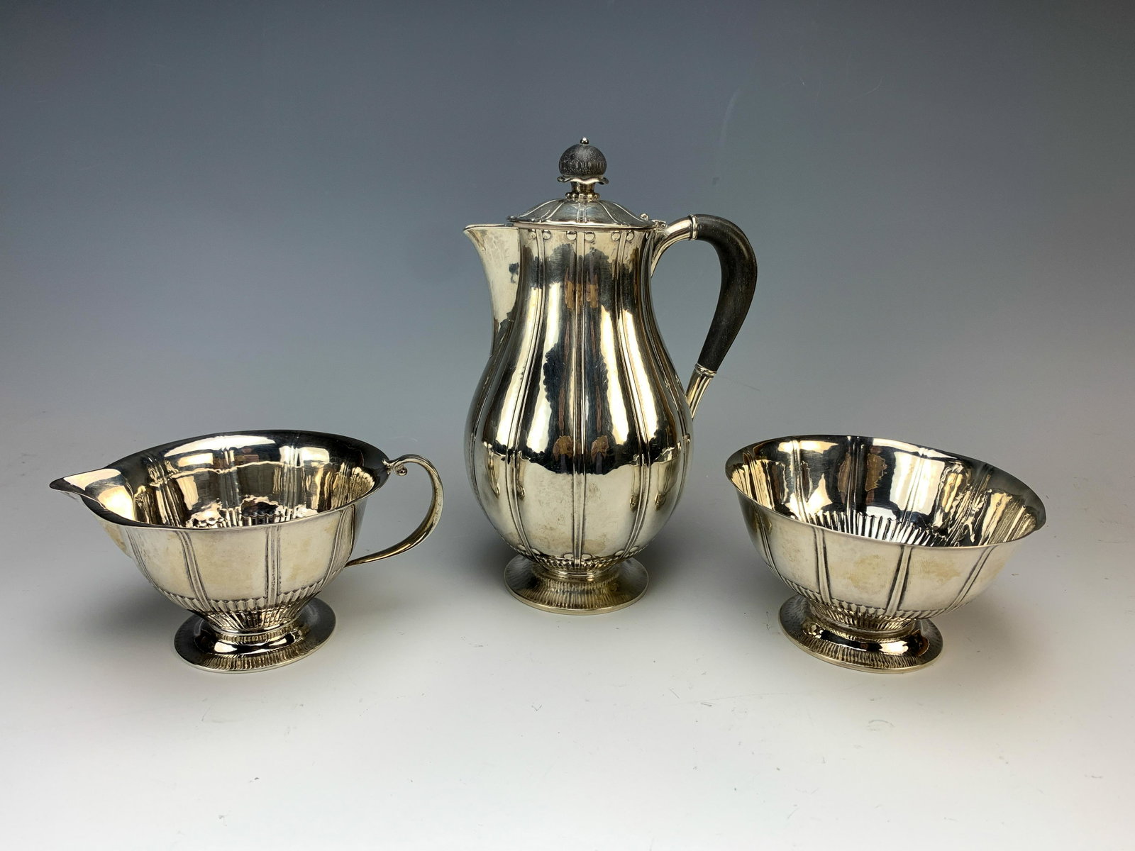 Georg Jensen 3-piece Sterling Tea Set: Teapot with ebonized handle and finial. Creamer and sugar. All properly marked with jensen marks. 726grams TW. Size: 7" 5/8 tall. Condition: Good!