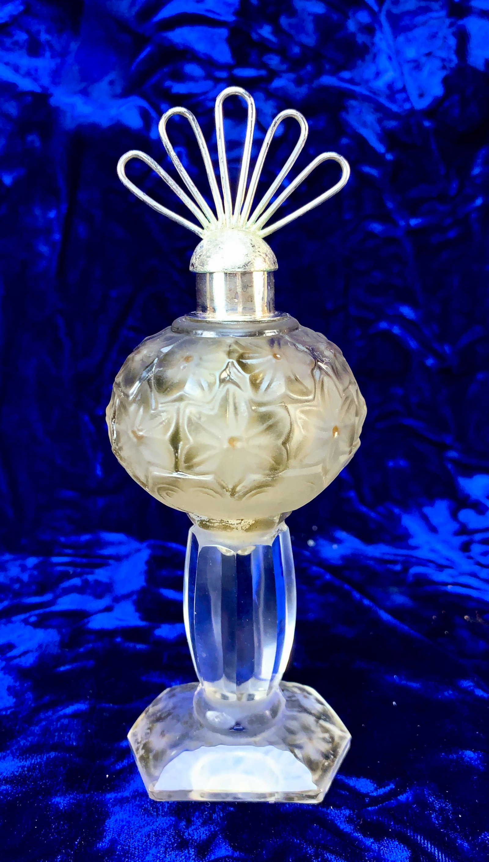 Perfume Bottle in the Manner of Lalique: Perfume Bottle in the Manner of Lalique, with 800 silver stopper, opalescent molded pressed glass, and enamel highlights. Silver stopper marked 800 and hallmark (fatt main). Glass marked with spurious