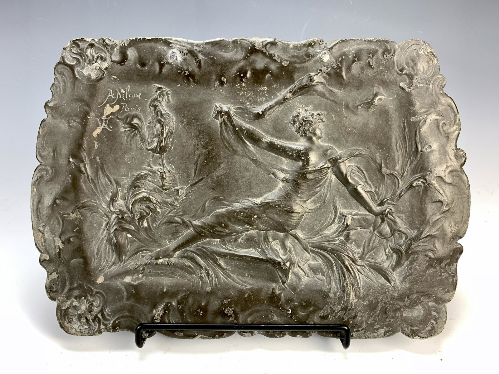 Art Nouveau Pewter Tray "Lady w/Rooster" Signed: Circa 1900. Depicting a lady with scarf amongst vegetatian and a rooster on a stand. Signed A. Nelson, Paris; and in initials DK. Size: 14" long x 10" tall. Condition: fair to good.