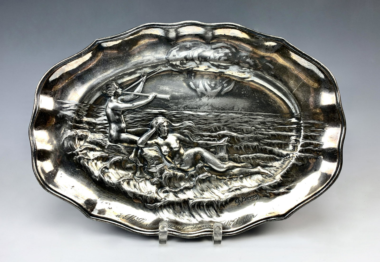 Art Nouveau Silver Plated Pewter Tray: Circa 1900. Artist signed CH Perron (French). Scene depicts two nude ladies with their musical instruments amongst the waves. Has a personal inscription in French. Size: 15" long. Condition: wear to p