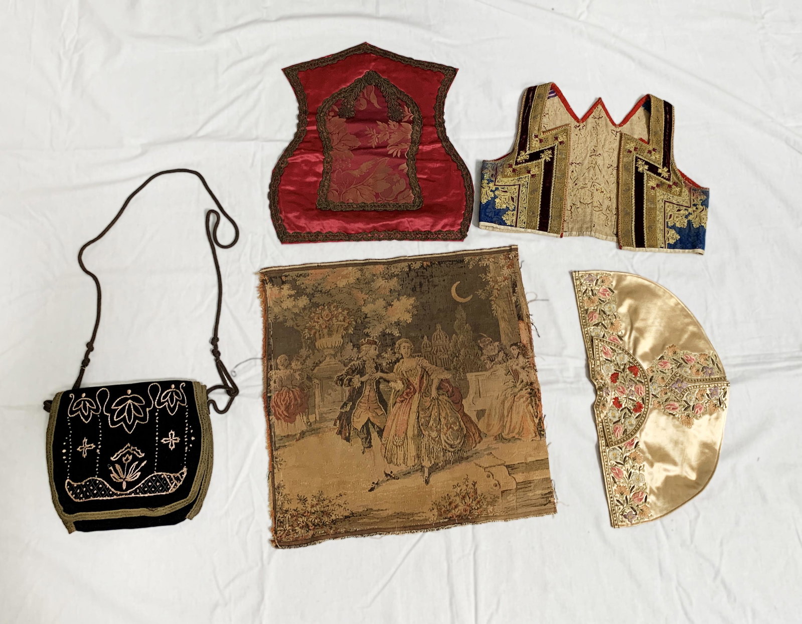 Set of Textiles & Crossbody Bag: A fantastic set of well-preserved textiles including: a small fabric vest of intricate designs and different textures and fabrics in colors of gold, black, blue and beige; a fabric hand fan made of a 
