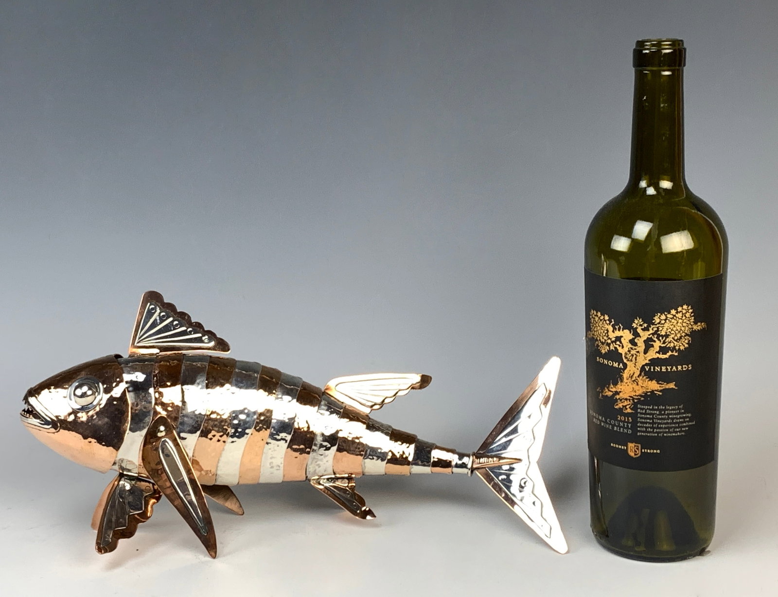Graziella Laffi Copper Fish w/Sterling Accents: Graziella Laffi (Peru) Copper Fish With Sterling Accents. This articulated fish in the piranha style measures 12" long and weighs 561 grams. It is an 'uncommon' size. Has some sterling silver joints a