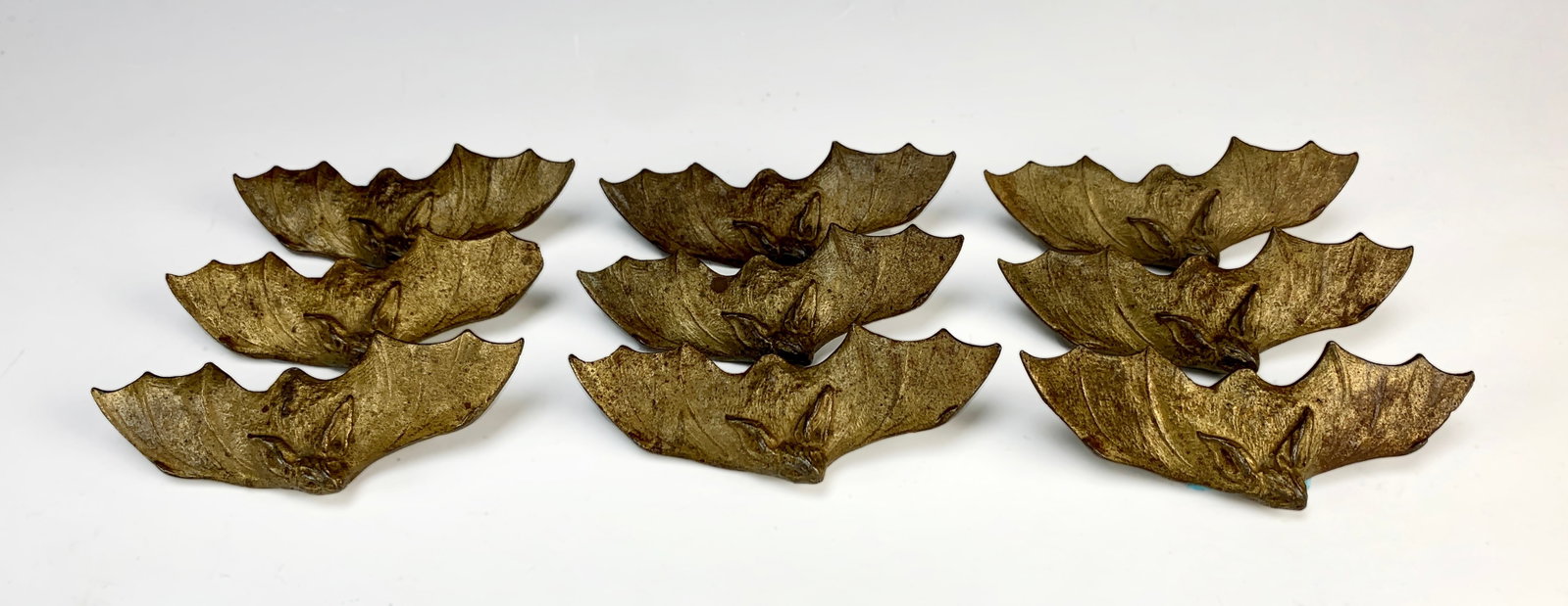 Set of 9 Bronze Bat Ornaments C1880: Also rare is to find these 9 bronze ornaments of spread wing bats. Each except one has a threaded posts for attaching. Size: 5" wide each x 1.5" height. Condition: good! wear to patina from age.