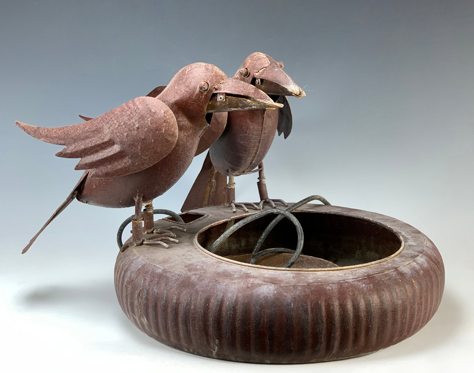 Two Metal Crows Fountain: Circa 1920s. Humorous fountain depicting two crows sitting on the edge of a large bowl. Size: 22" wide x 14" tall. Condition: Good, light wear to paint from age. Should be looked into by an electricia