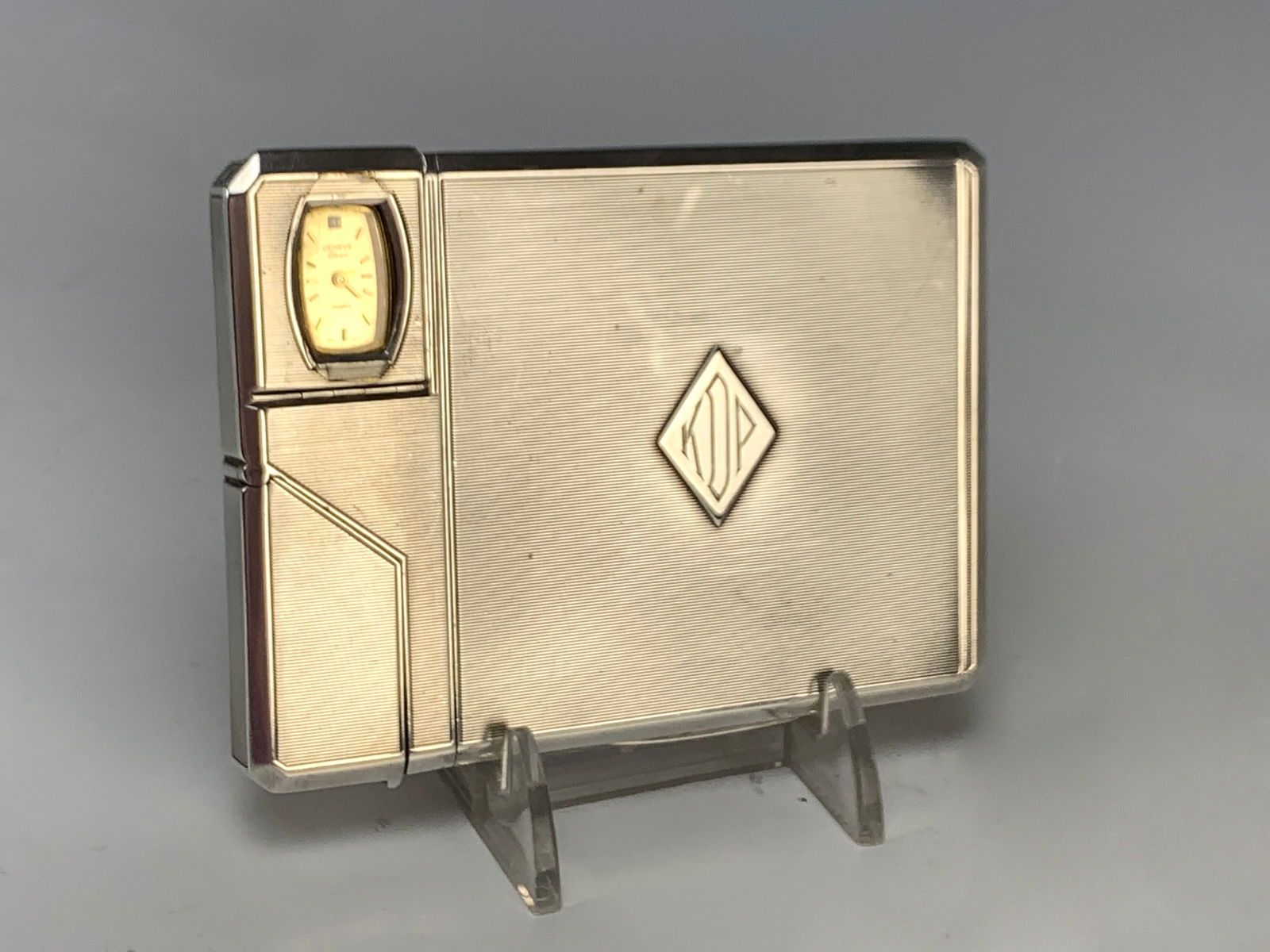 Rare Dunhill Cigarette Case, Lighter And Watch: A magnificent rare Alfred Dunhill hallmarked case with concealed lighter and watch. In sterling with hallmarks AD (Dunhill), lion, leopard, and date N (1928-29). Also marked in the upper left corner "