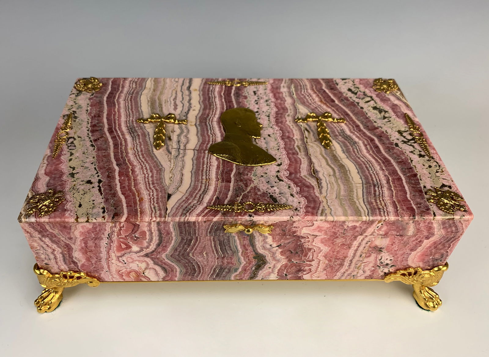 Large Rhodochrosite Jewelry Box w/Velvet Interior: Beautiful stone box cut from rhodochrosite, featuring a hinged lid and a grey velvet interior. The outside of the box is decorated with gilt bronze of Nicholas II in the center, Russian double eagles