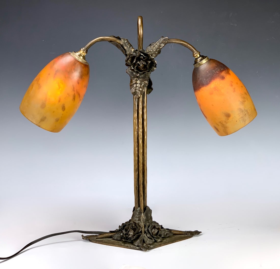 Daum Nancy Sgd Double Desk Lamp C. 1900: Pair of signed Daum Nancy mottled orange glass shades mounted with bronze lamp standard decorated with protruding flowers and leaves, good condition, minor flake on fitter, 16.25" height *Electrical w