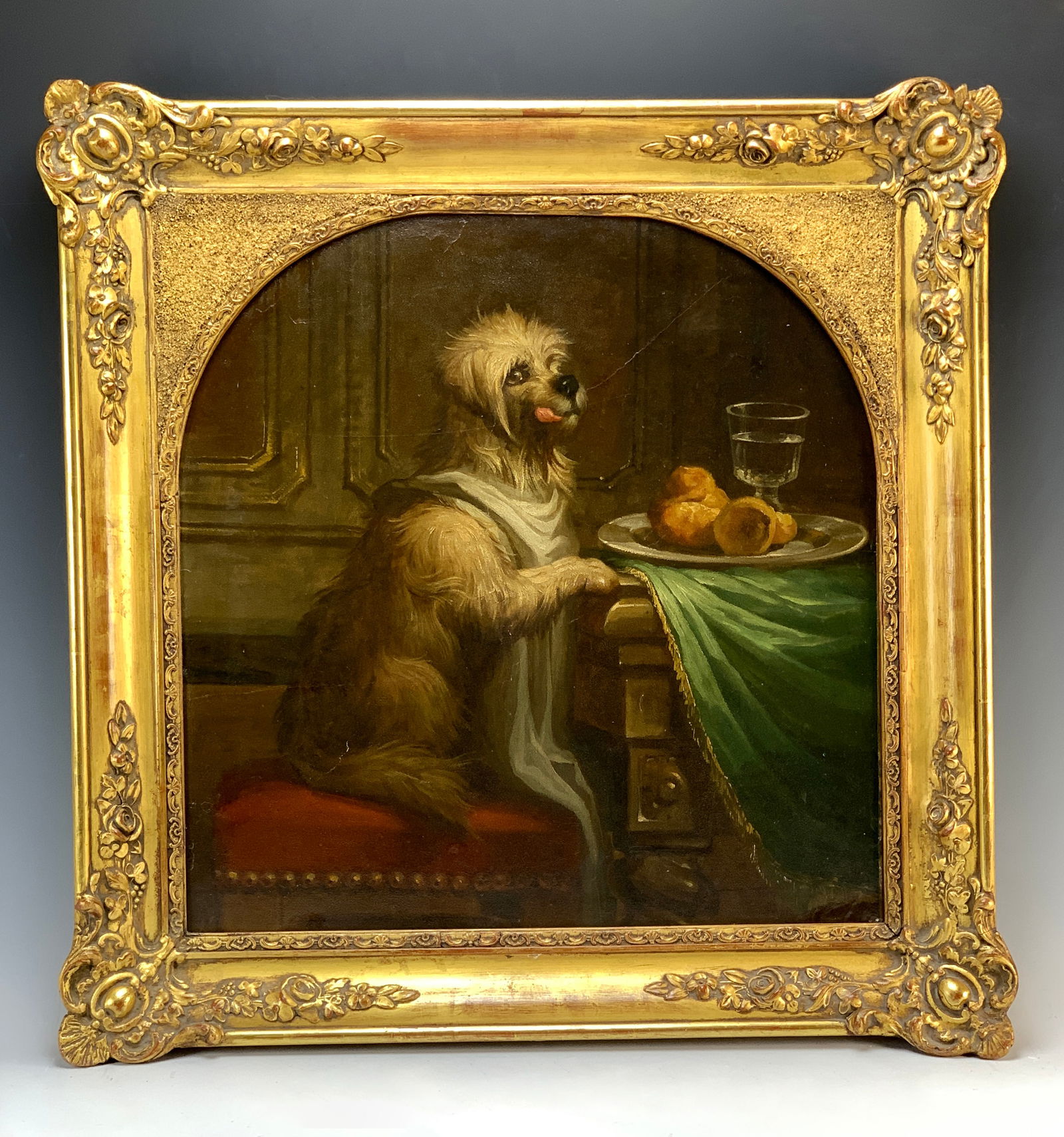 19thC English School Painting "Hungry Dog": Circa 1870. Charming and humorous dog painting depicting a terrier with his tongue hanging out, eyeing the plate of food in front of him. Mounted in its original gilt cut-out frame. Unsigned. Size: 19