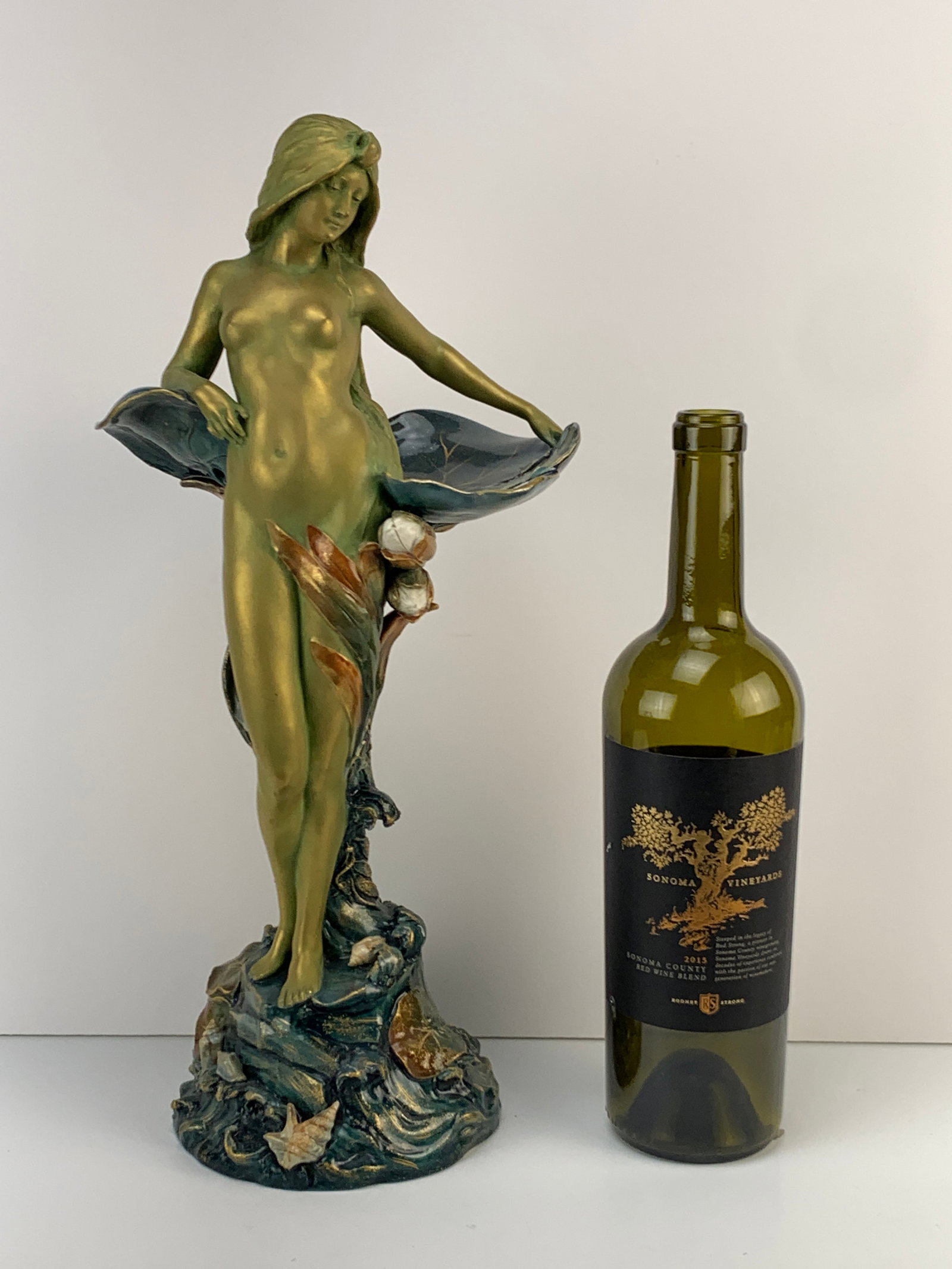 Ernst Wahliss Amphora Porcelain Waterlily Nude: Circa 1900s. Gorgeous Art Nouveau nude female in a gold/green iridescent color against polychrome lily pads, standing above a mound of lily pads and seashells. Signed on the bottom with the Ernst Wahl
