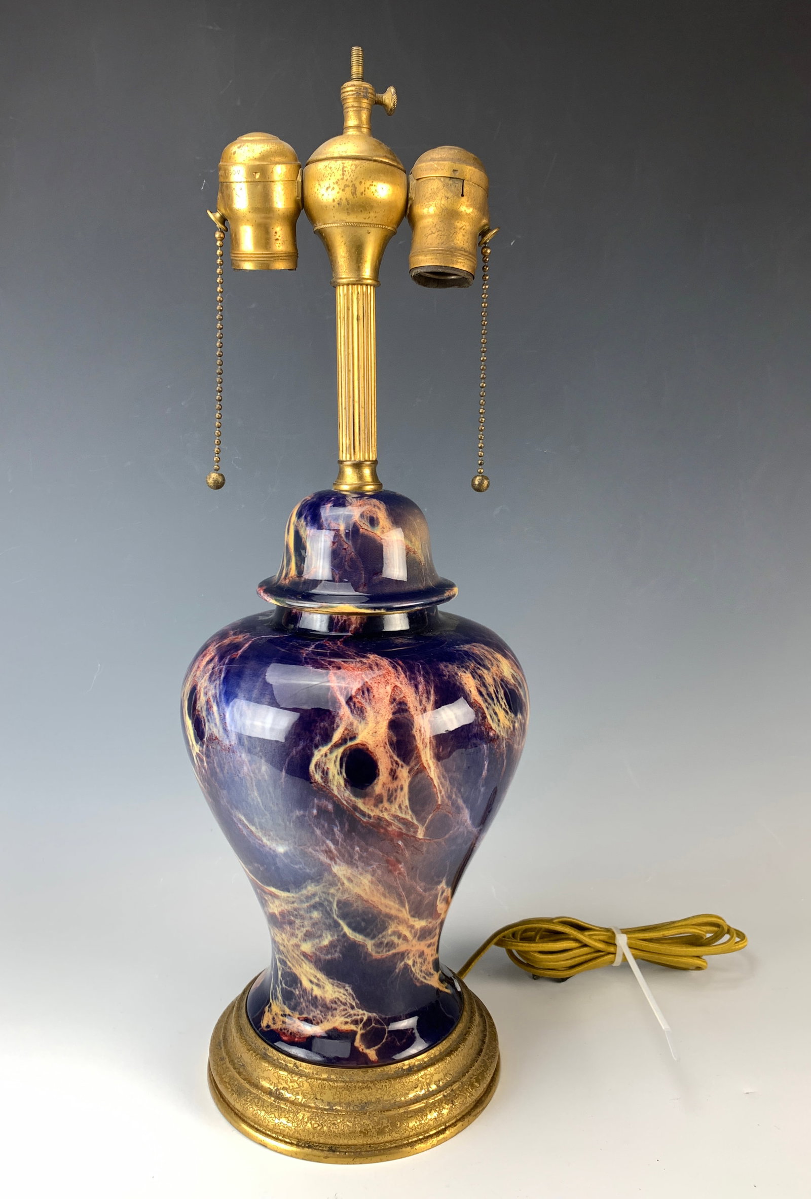 Ceramic Lamp w/Bronze Mounts by Tiffany Furnaces: A ceramic lamp with bronze mounts on the bottom, marked "Mounted by Louis C. Tiffany Furnaces, Inc." Size: 20.5" tall. Condition: Good, missing finial.
