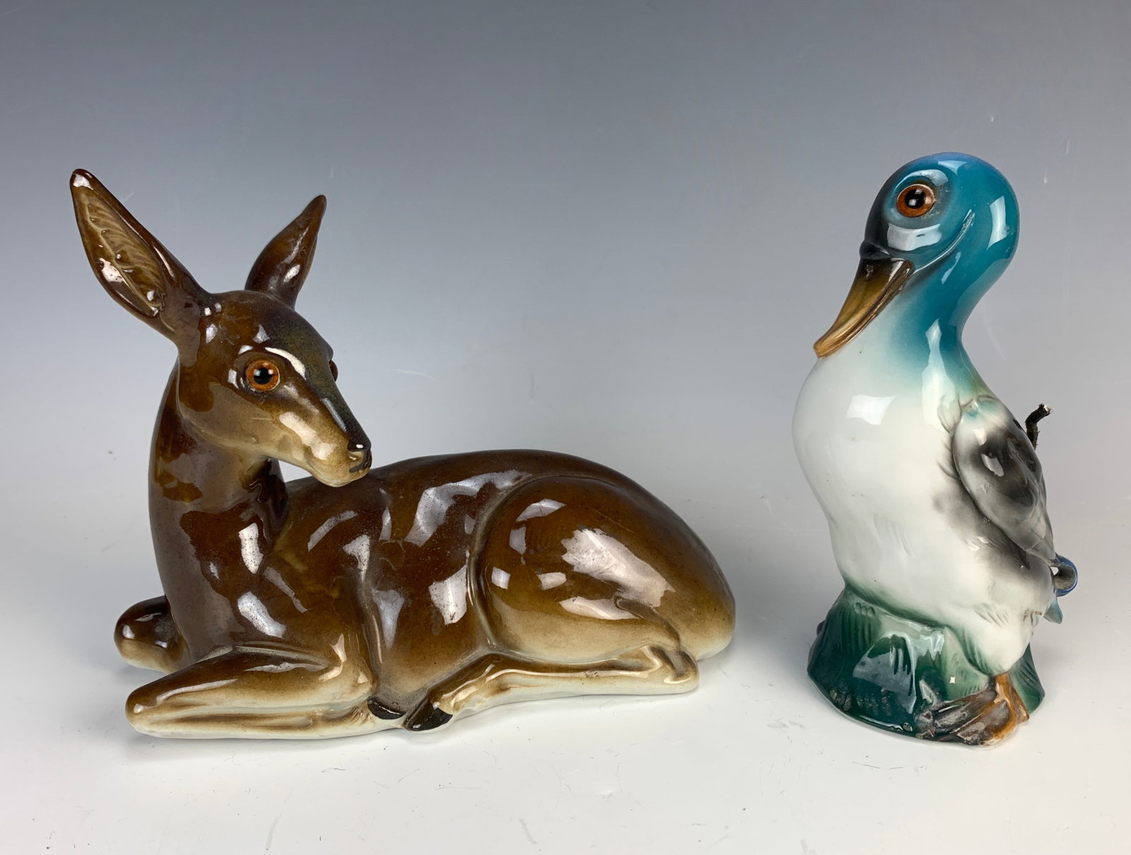 2 Vintage Porcelain Perfume Lamps: Circa 1930s, this includes 2 porcelain perfume lamps, one having a deer and the other a duck. Size: 8" longest. Condition: Good, plugs removed for safety reasons.