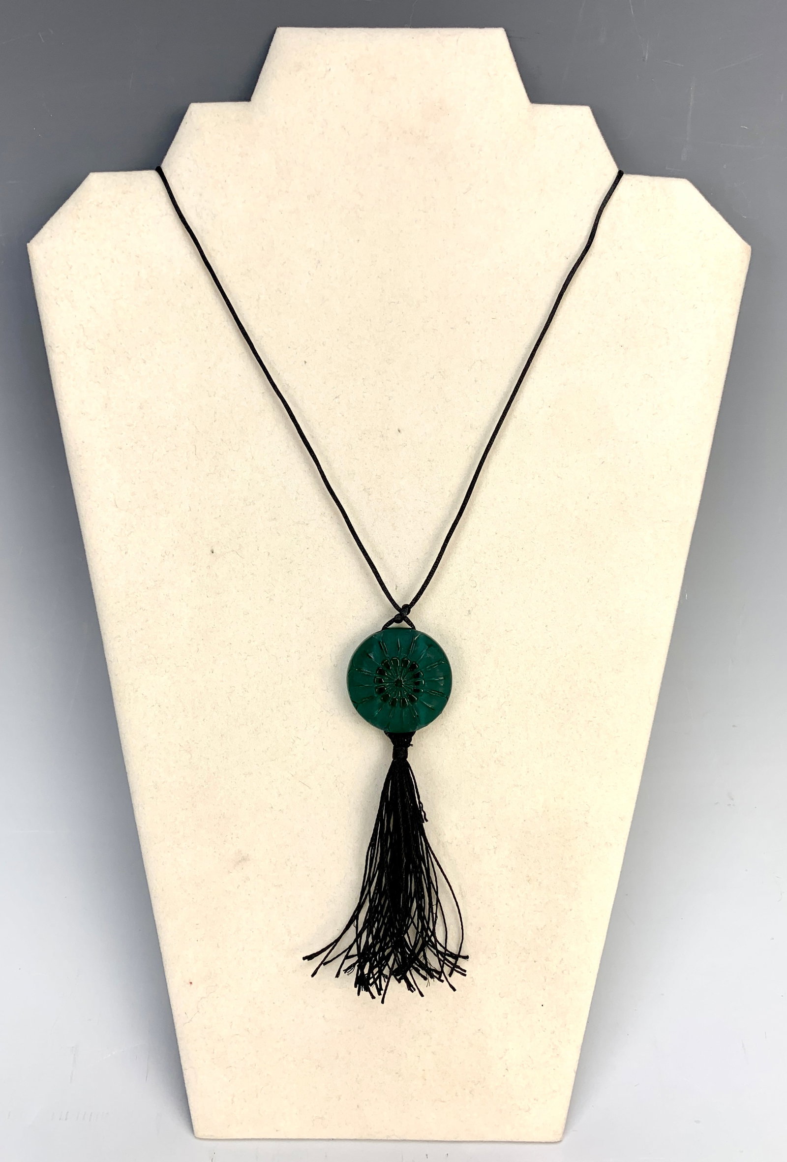 Lalique "Margueritte" Green Glass Pendant: Circa 1919. Rene Lalique green glass pendant "Margueritte" mounted in a black silk cord. Created in 1919, mold #1030. Signed Lalique. Ref. Felix Marcilhac #1616, page 572. U.R. Very good condition, 1 