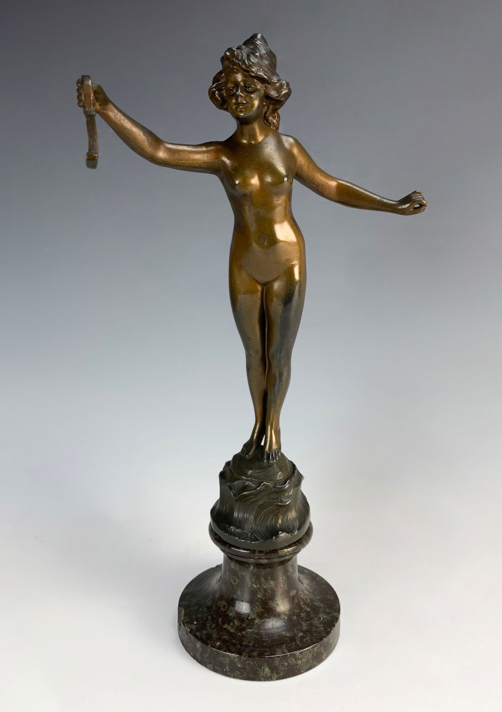 Franz Iffland (German 1862-1935) Nude Watch Holder: Wonderful bronze figure of a nude lady with her right arm extended holding a hook for hanging a pocket watch. Signed in the bronze "F. Iffland", also marked "Germany". Mounted on a sculptured marble b