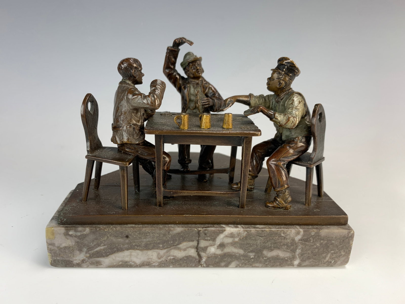 Bronze Fig.Group "Playing Cards" Sgd. R. Hobold: Early 20th century, this polychrome bronze miniature group depicts three card players sitting at a table. It is signed "R. Hobold" and mounted atop a grey-veined marble triangular base. Size: 4.25" ta