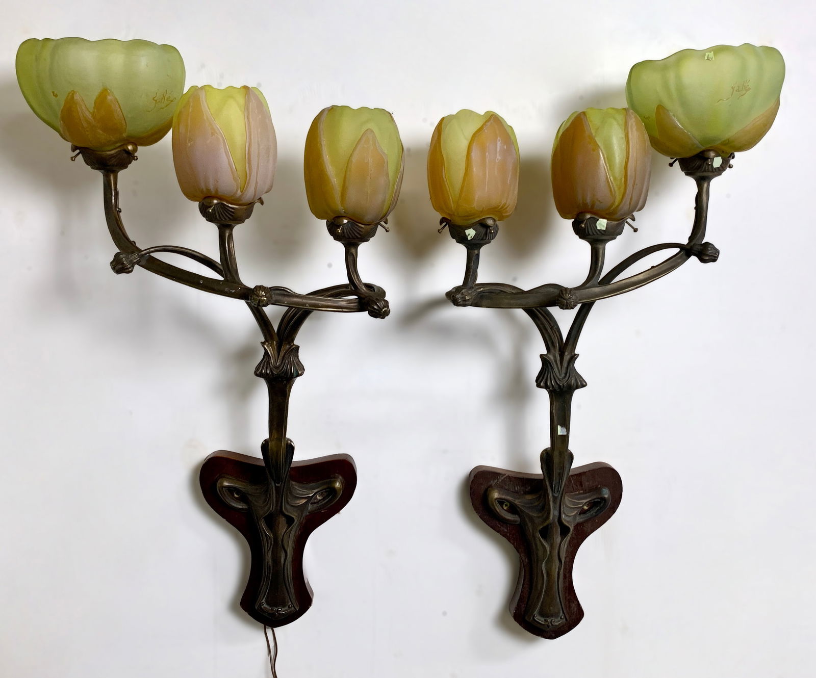 Daum Nancy & Majorelle Rare Reproductions Sconces: An exceptional pair of reproduction sconces in the manner of Daum Nancy and Majorelle, signed Galle. Each has three bronze arms with thick blown-out two-tone colored glass shades: one large shade and