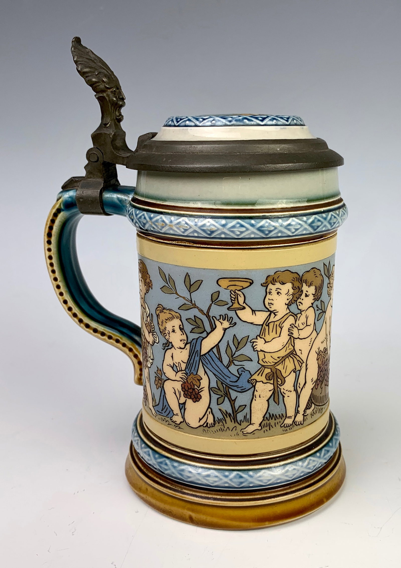 Mettlach 1/4 Liter "Children" Etched Stein: Great Mettlach stein made in Germany, 1/4 liter, decorated with a row of playing children, marked "2121" with Mettlach factory marks. Size: 5.5" height not including thumb. Condition: Very good.