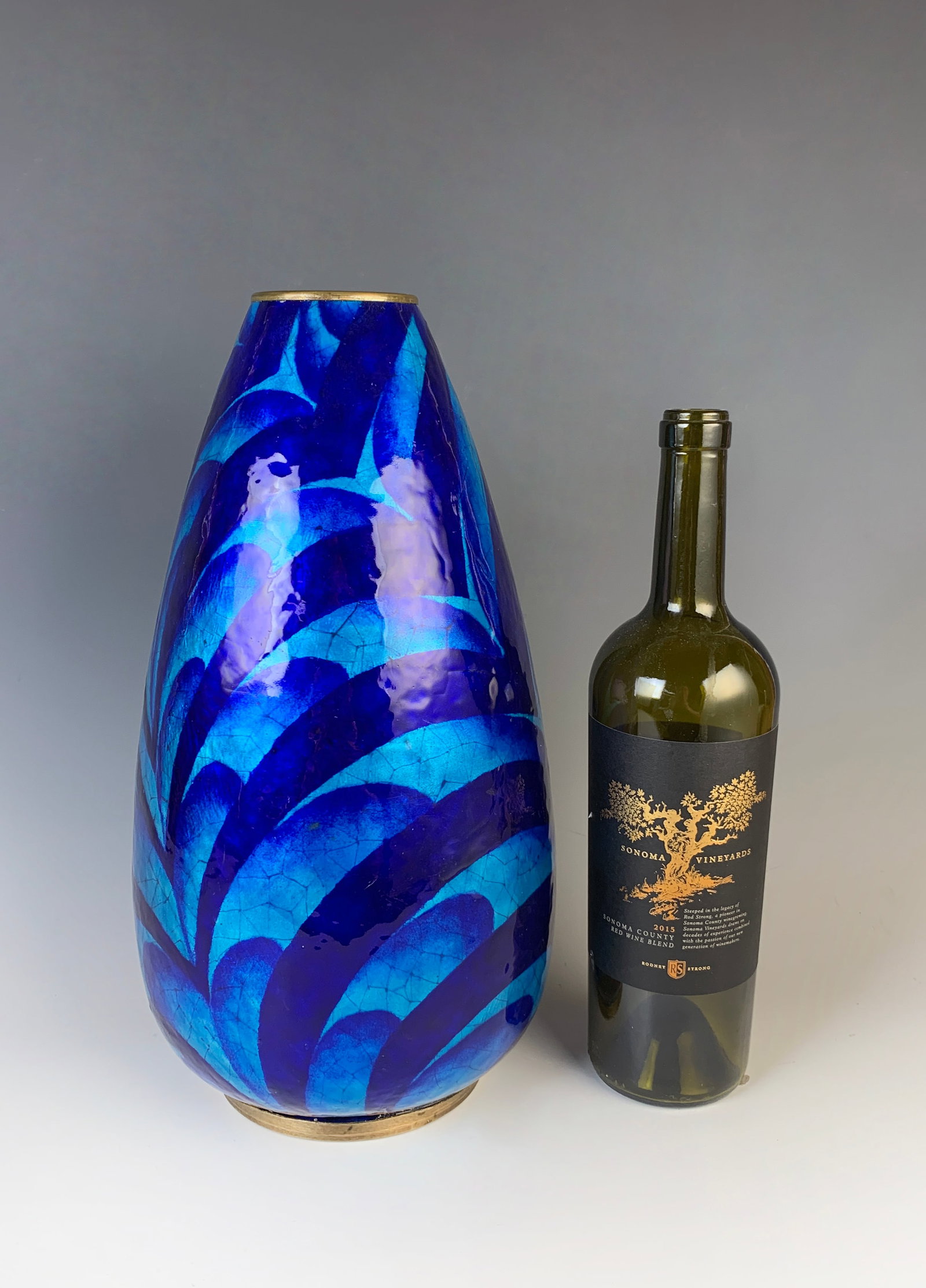 Jules Sarlandie (1874-1936) Art Deco Enamel Vase: Early 20th century. Enamel over copper by an enamel artist from Limoges, France. A tall teardrop enamel Art Deco vase decorated in waves of dark blue to light blue geometric designs. Signed "Sarlandie