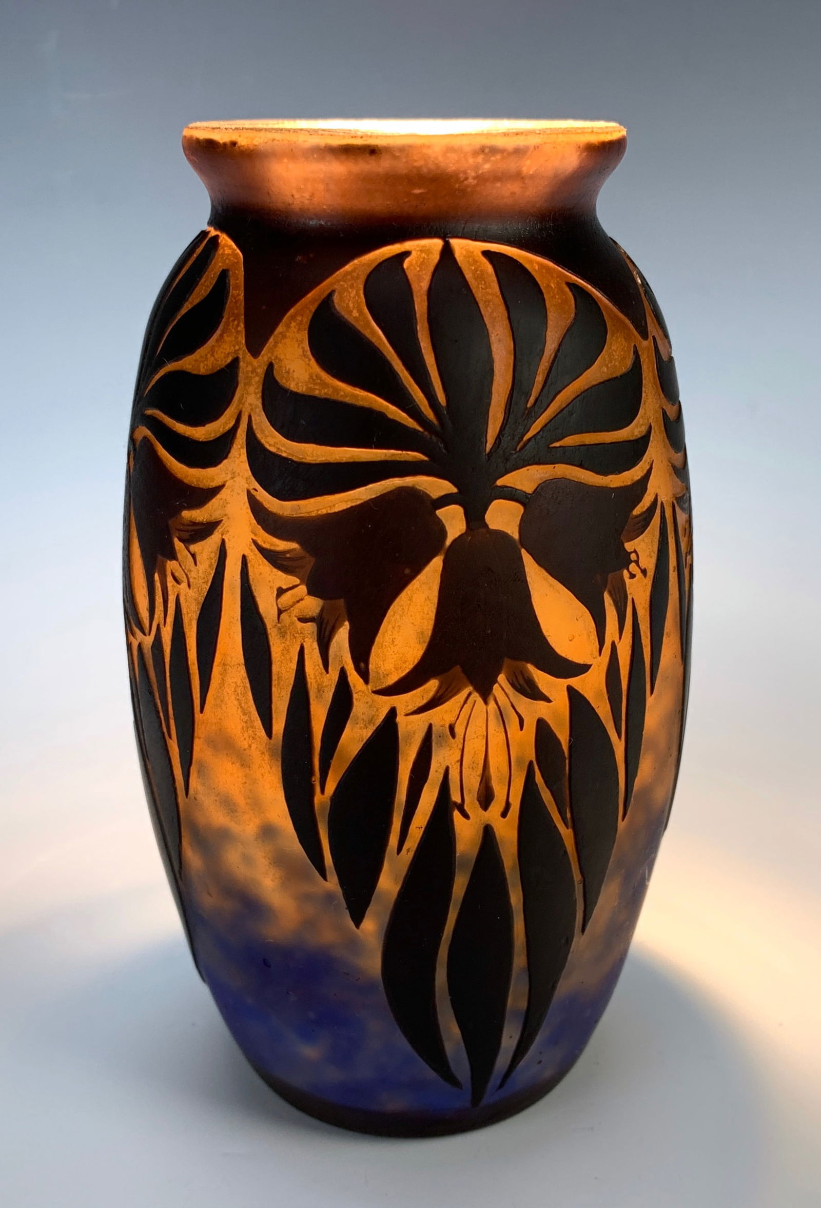 Muller Freres "Papyrus" Cameo Glass Vase C.1910: Signed "Muller Freres, Luneville", featuring a brown etched decor of papyrus on an orange tinted background with blue interlayer powders. Size: 6.25" height. Condition: Very good.
