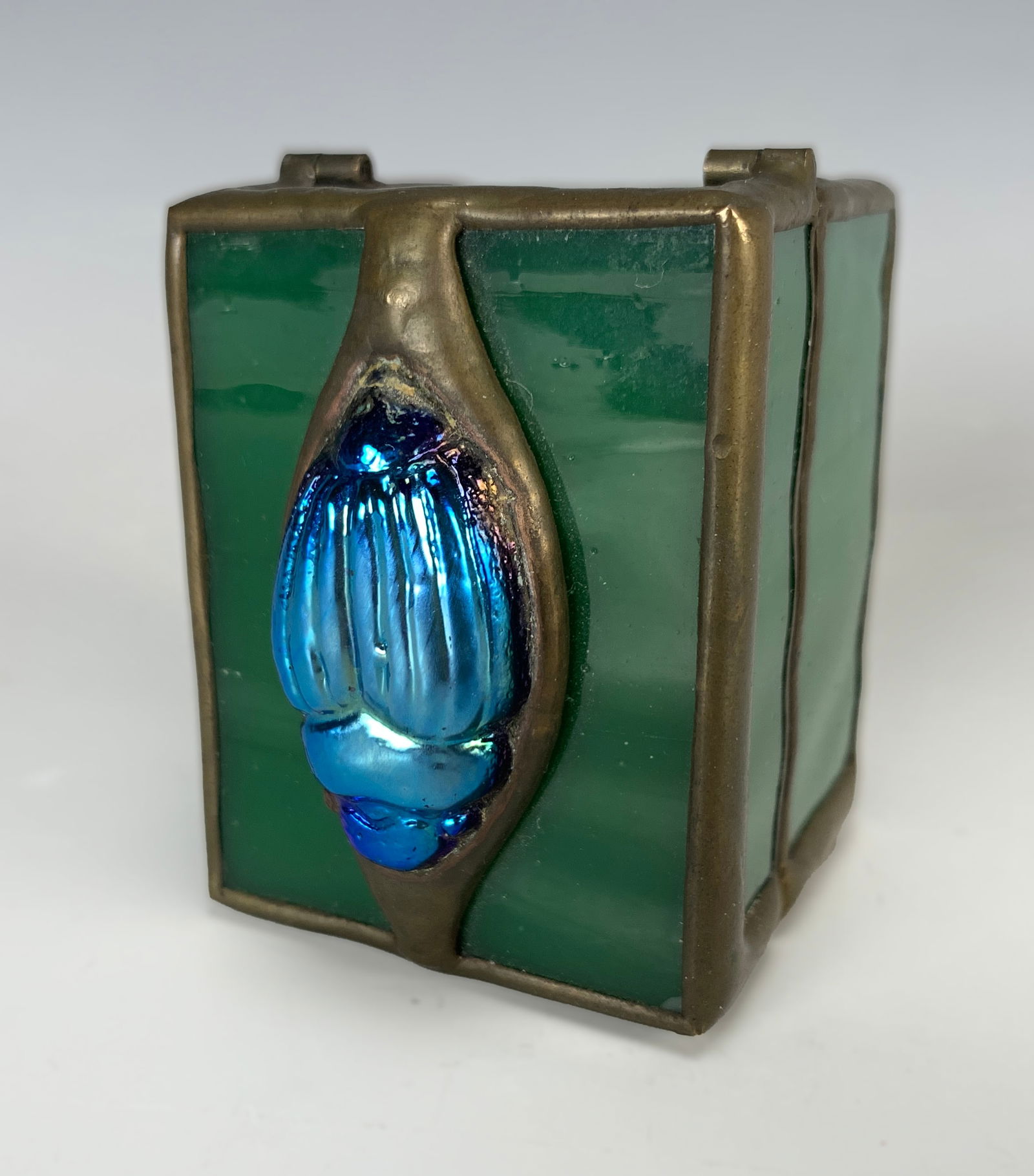 Orient & Flume Glass Box with Scarab: Orient and Flume, known mostly for their art glass. The box is leaded in green slag glass and decorated with an iridescent blue scarab on top. Signed Orient & Flume and dated 1999, with a paper label