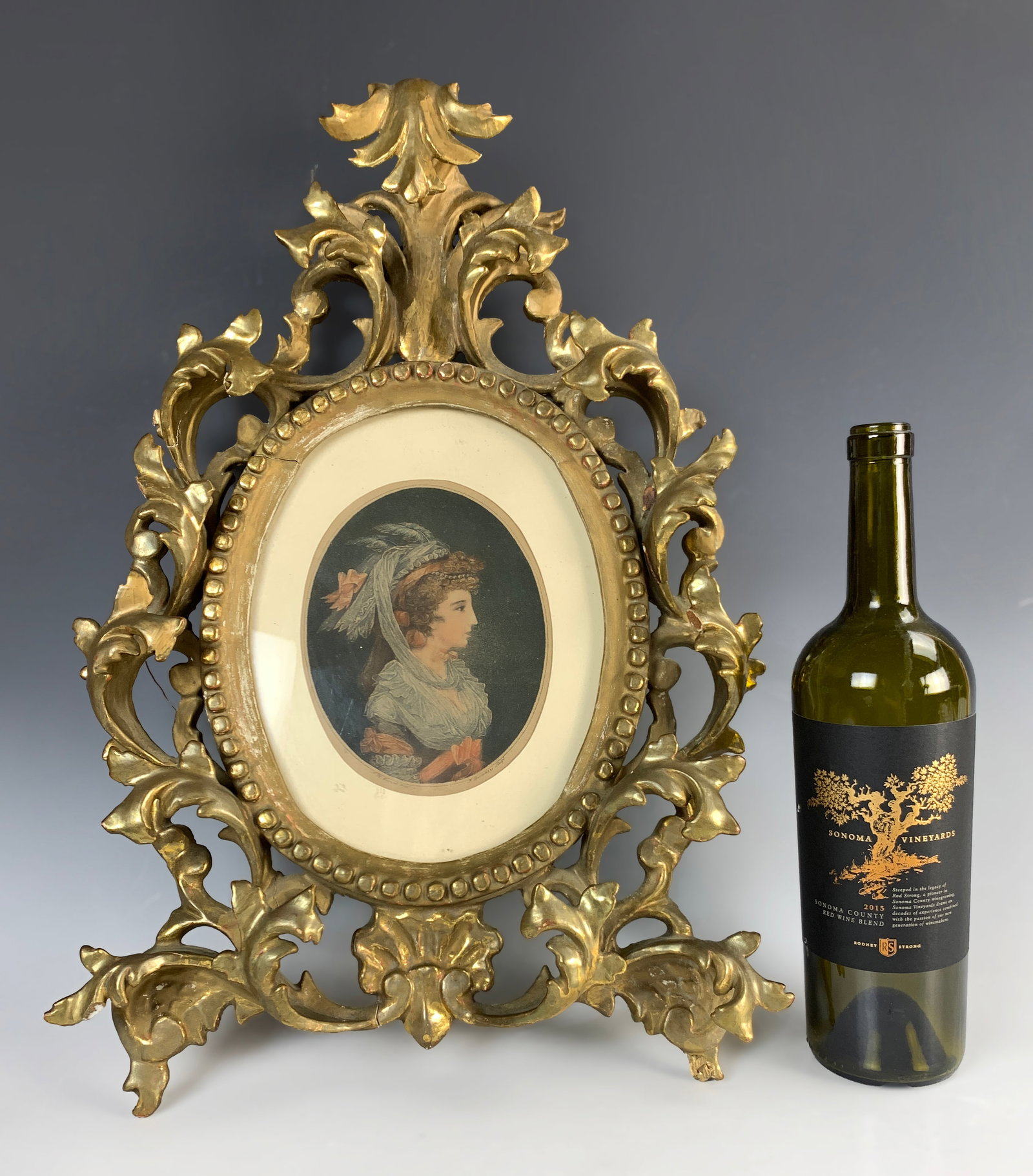Florentine Gilded Oval Frame, Takes 8x10 Pic: This is a larger gilt oval Florentine frame that fits an 8" x 10" plaque. Size: 20" tall x 13.5" wide, with an opening of 8" x 10" oval. Condition: Fair to good, with some damage to areas.