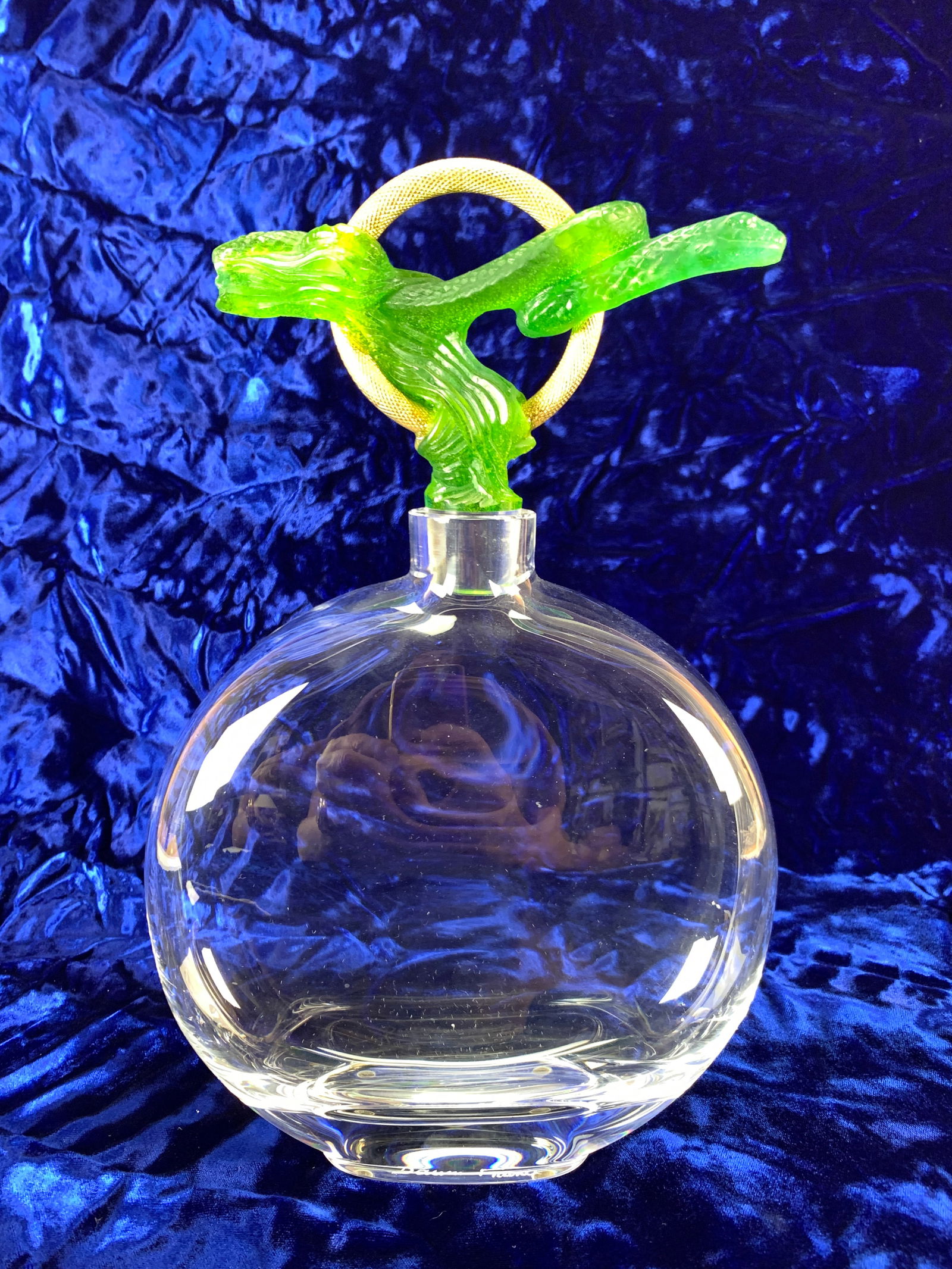 Daum France Pate de Verre Art Glass Decanter: Daum France pate de verre art glass decanter. "Carafe de Torques" with green snake. Clear glass decanter with a green pate de verre snake stopper and a gilt bronze ring. Base marked Daum France. Size: