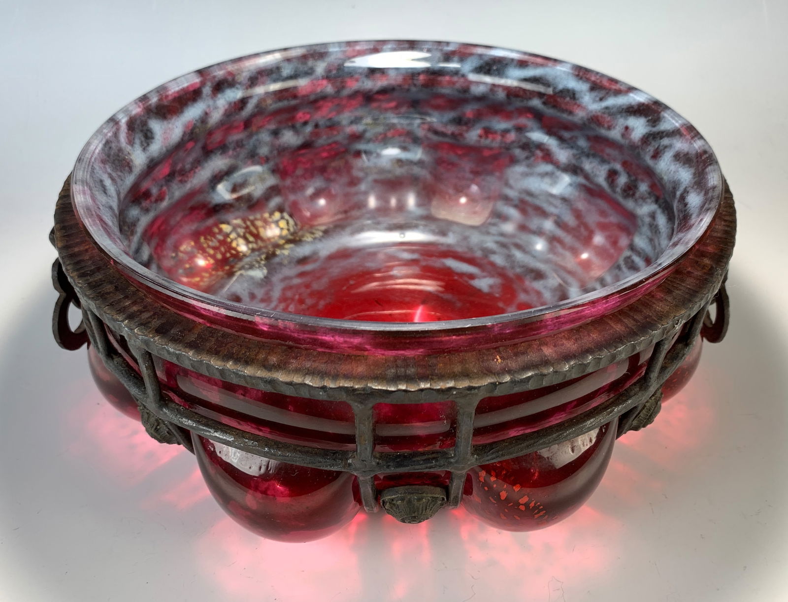 Daum Nancy & Louis Majorelle Large Sgd Bowl: Oversized bowl, high rim bowl in dark red mottled glass, with inclusions of exploded metal leaves. Blown into a patinated iron rib form frame and signed on the bottom Daum Nancy & L Majorelle. Size: 4