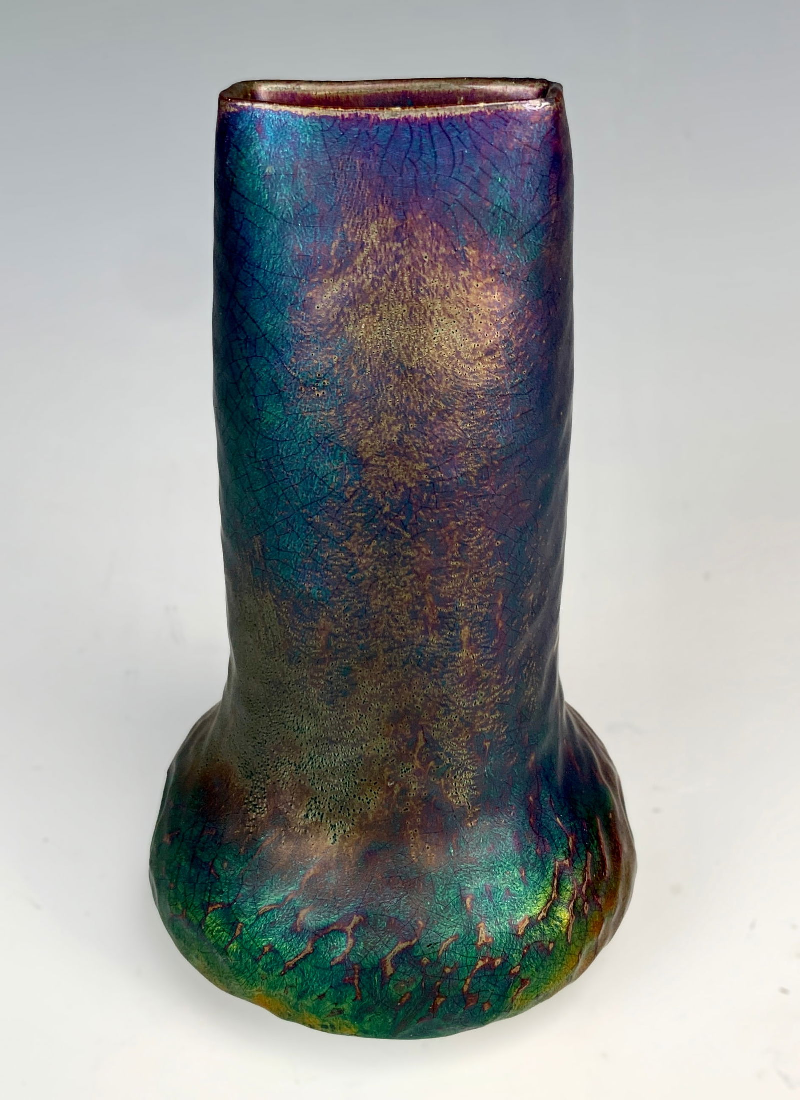 Delphin Massier (1836-1907) Art Nouveau Vase: A beautiful iridescent vase with a high neck in glazed ceramic, featuring metalized reflections and two dimples at the bottom. It is signed "Delphin Massier Vallauris AM." Size: 6" tall. Condition: ve