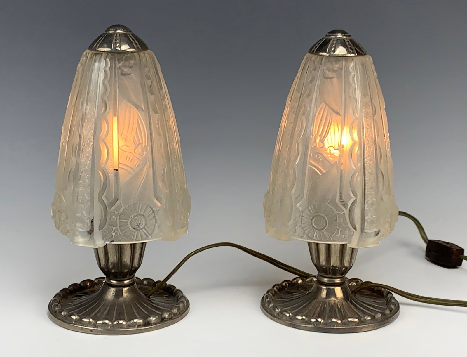 Pair Art Deco Boudoir Lamps Sgd Donna: Circa 1930's. Each shade is molded with geometric frosted clear shades signed Donna Paris. Mounted on original silver over bronze bases. These lamps are unique and in excellent condition. Size: 8.25" 