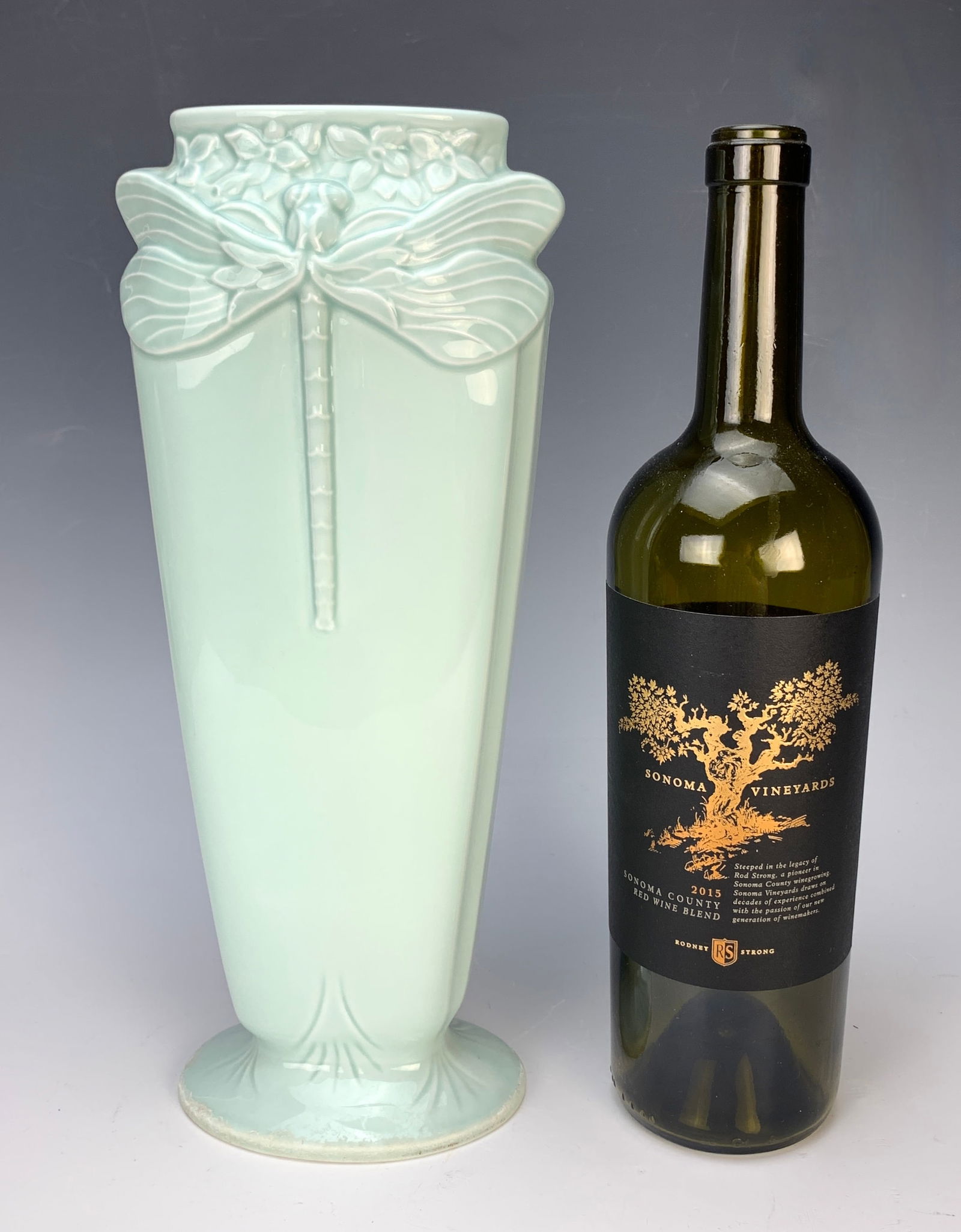 Christofle Porcelain "Dragonfly" Vase: Having a sea green color vase decorated with a dragonfly mounted on each side. Marked Christofle. Size: 12" tall. Very good condition.