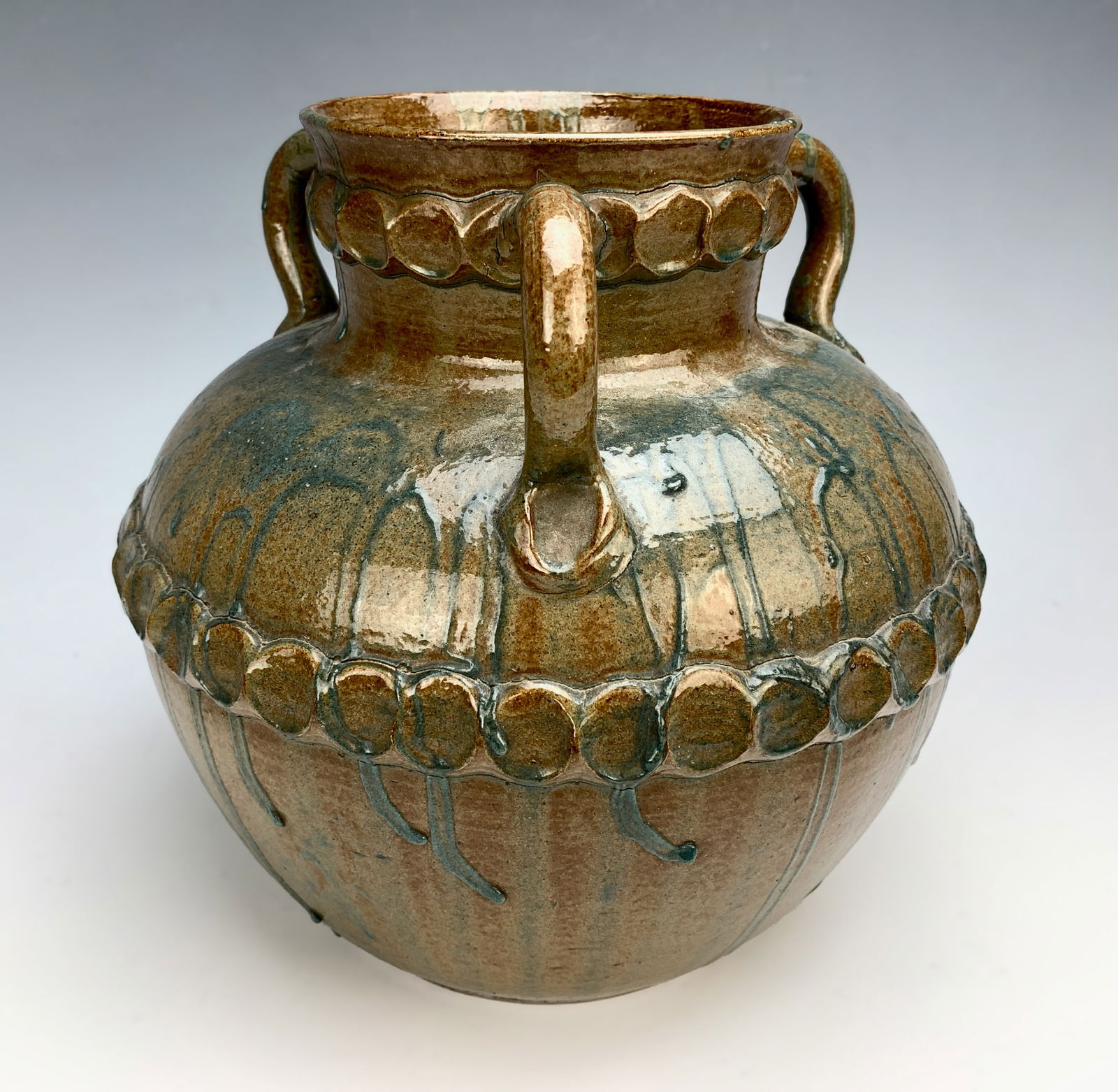 Large Auguste Delaherche Vase: Auguste Delaherche (French 1857-1940) a three handled vase having a wide belly and flared narrow neck in ochre enameled sandstone with green drips and decorated with pellets, marked, good condition, s