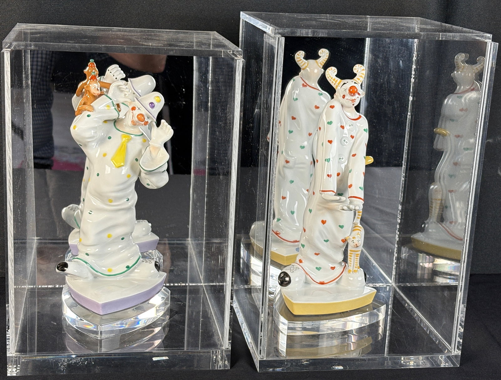 Pr Schwarzburger Werkstatte Porcelain Clowns sgd: Late 20th century, A pair of standing hand painted porcelain clown figurines both signed with the Schwarzburger Werkstatte Volkstedt mark, designed by Kati Zorn. One clown with both hands raised and a