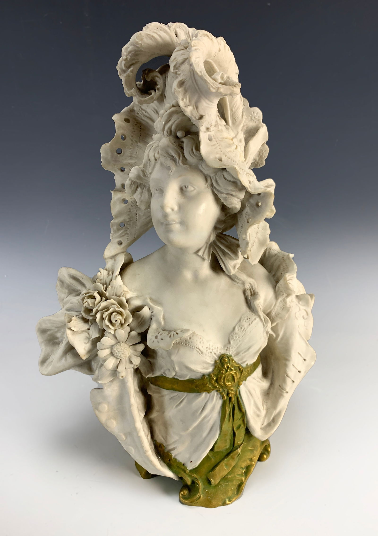 Ernst Wahliss (1837-1900) Bust of a Maiden: Circa 1890. Beautiful art nouveau bisque porcelain lady with a fancy hat made by well-known maker Ernst Wahliss. Signed with the crown mark. Size: 15" tall x 10" wide. Condition: very good.