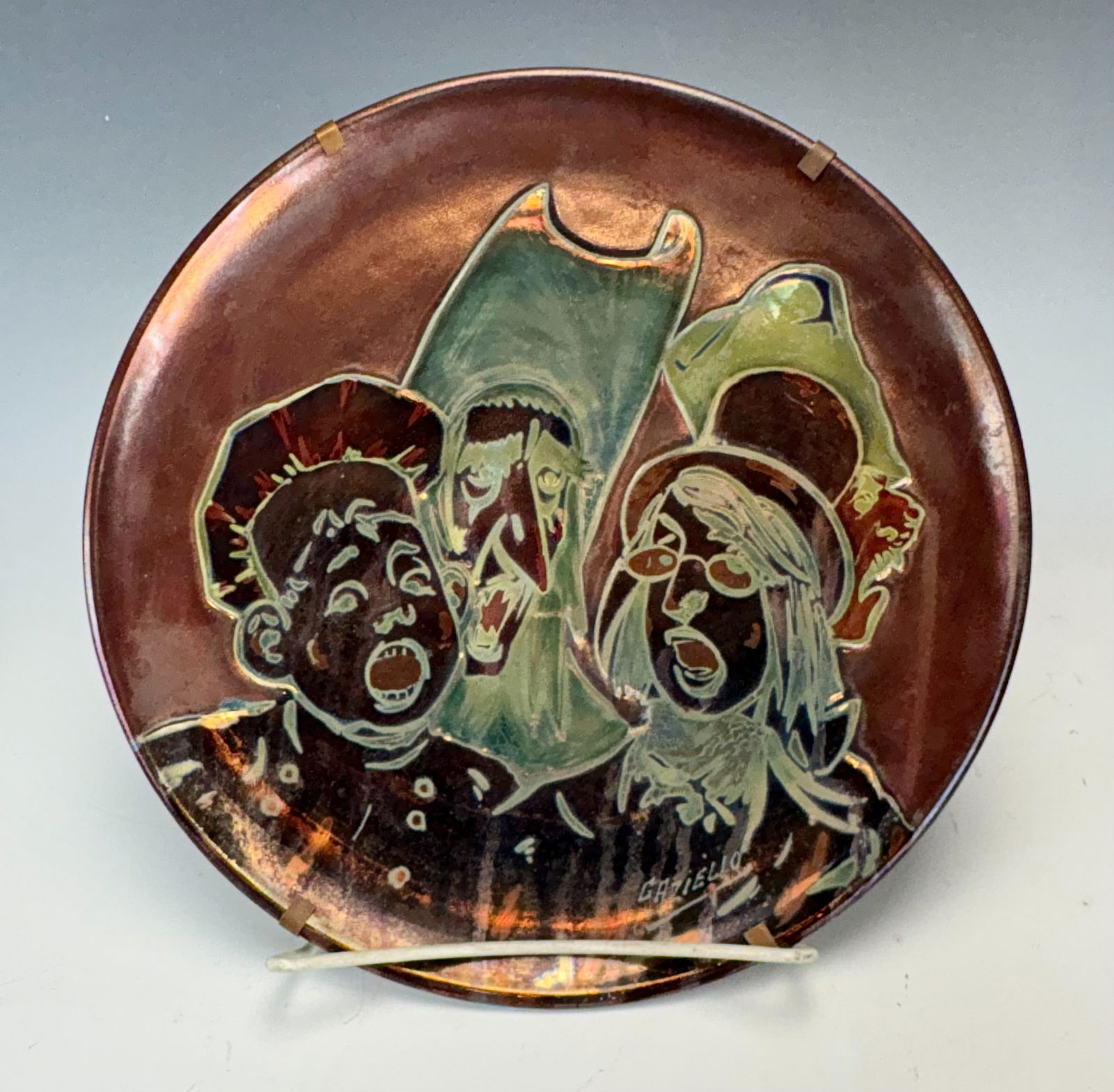 Rare Massier Plate Trio of Singers Artist Signed: Early 20th century, Jerome Massier (French 1850-1926) brother of Clement Massier who operated his factory in Vallauris, France, a very rare ceramic plate in rich scarlet, gold and teal iridescence dep