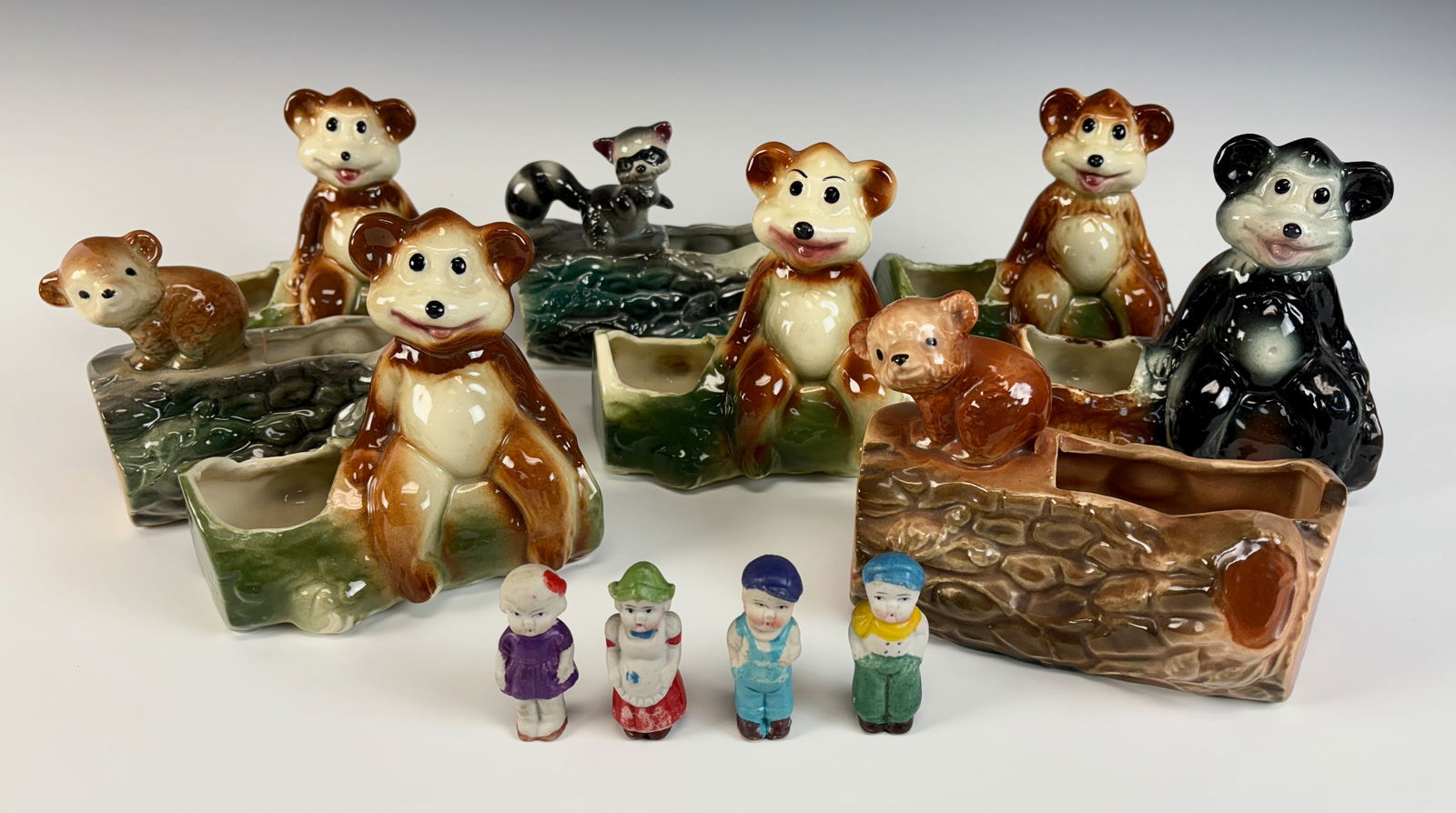 Lot of 12, 8 Bear & Raccoon Planters & 4 Figurines: Large lot of 12 figural items consisting of 8 ceramic planters, 7 of seated bears and one raccoon, also in lot are 4 bisque figurines of children, all good condition, largest 5.5" x 6” *In-house