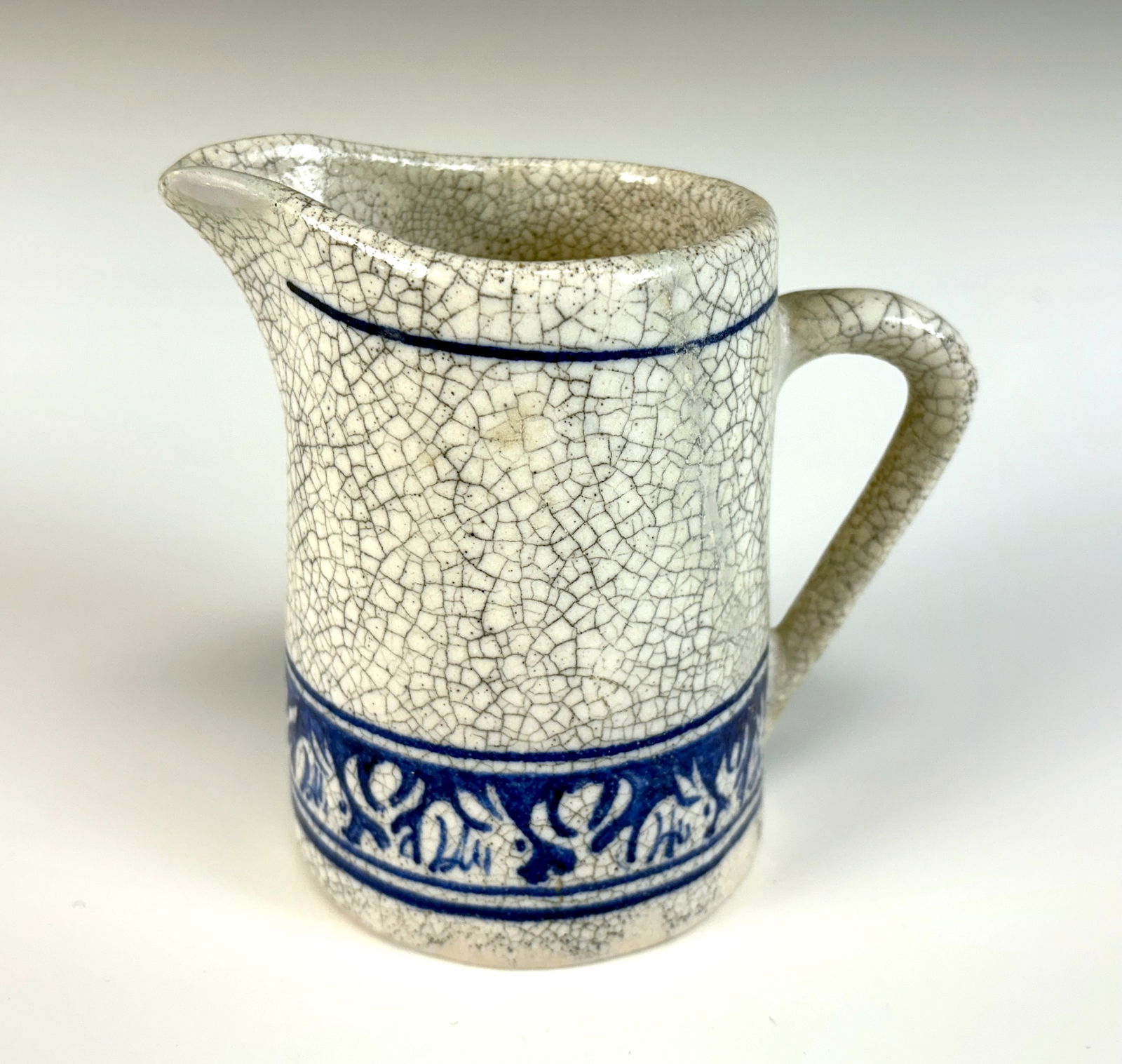 Dedham Rabbit Art Pottery Pitcher: Early 20th century, figural American art pottery pitcher modeled as a rabbit, inscribed on base "Dedham Pottery", very good condition, 4" x 4.5" *In-house shipping within the U.S. available for this l