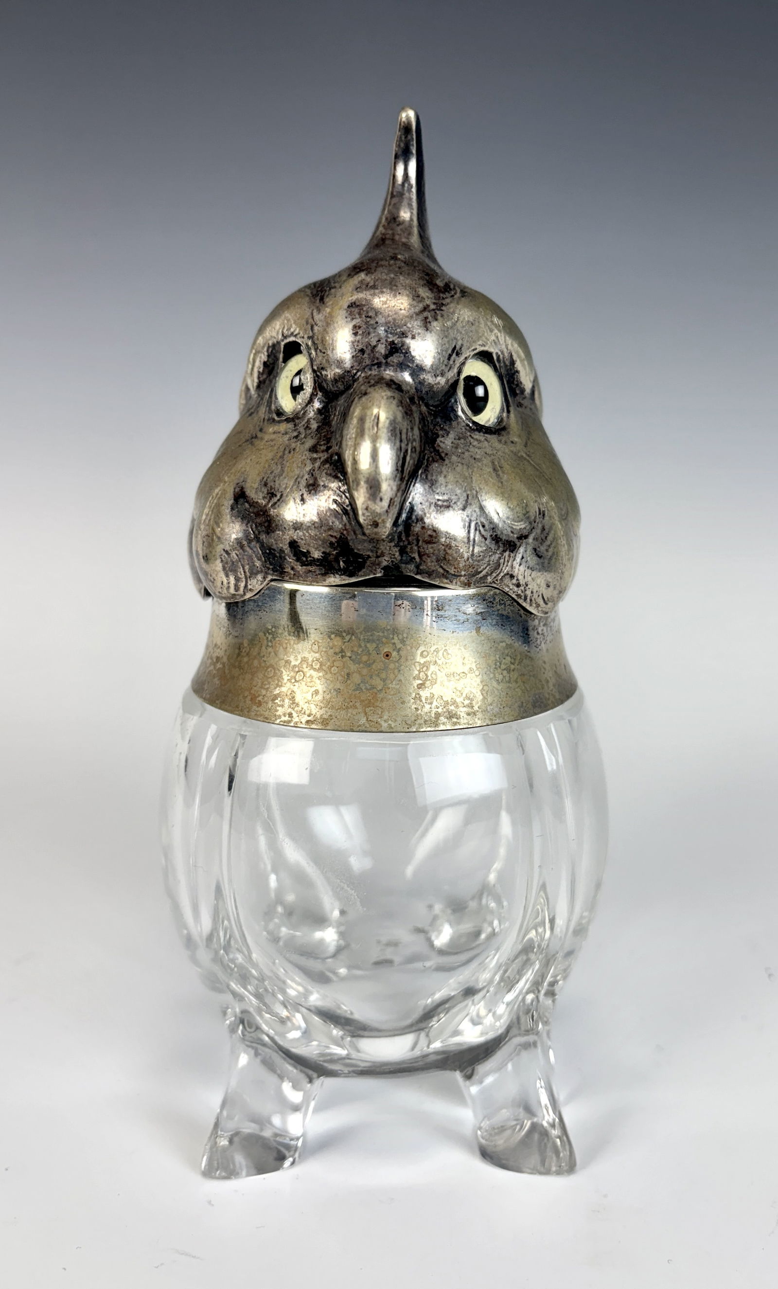 Antique Silver Plated Figural Cockatoo Jar: A glass footed jar with silverplate hinged lid modeled as a cockatoo or parrot's head with glass eyes. The lid conceals a condiment dish. It's very charmingly designed. The mold blown clear glass jar