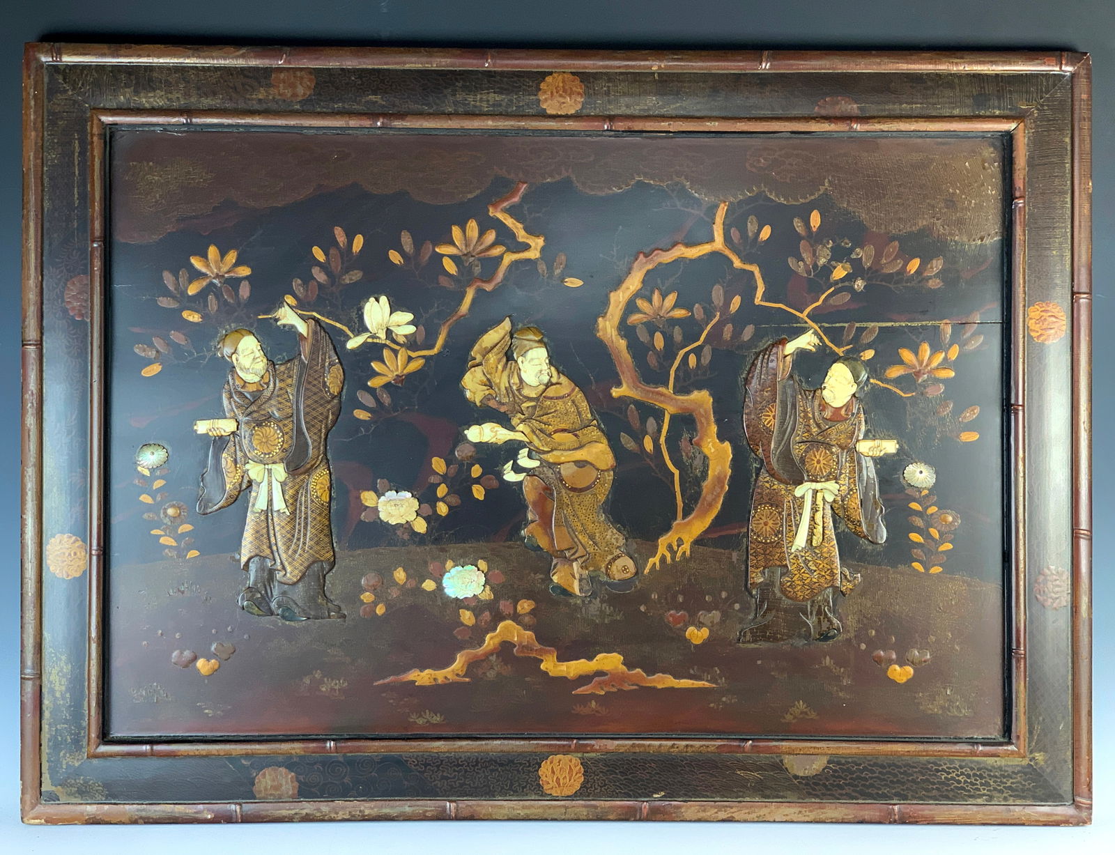 Antique Japanese Lacquer & Bone Wall Plaque: Circa 1900. Great wall item. Japanese lacquer and bone wall hanging featuring three immortals with their faces, hands, and belt adorned with bone carvings. Slight crack on the right center, minor spot