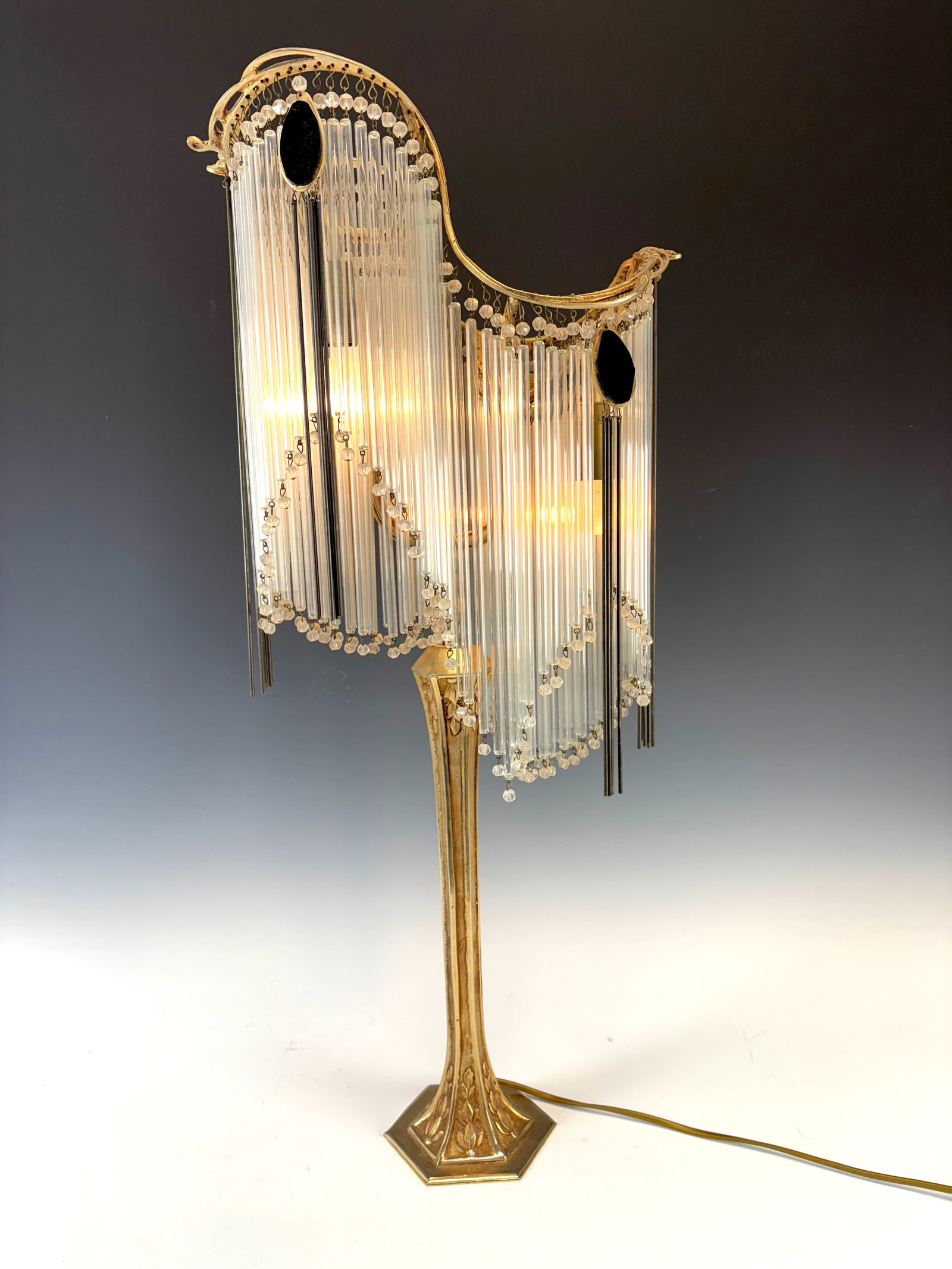 Art Nouveau Table Lamp after Hector Guimard: 20th C, a large and elegant table lamp of gilt bronze and tubular glass prisms after Hector Guimard, 4 European sockets, with raised octagonal tiered base, good condition, consult electrician about re