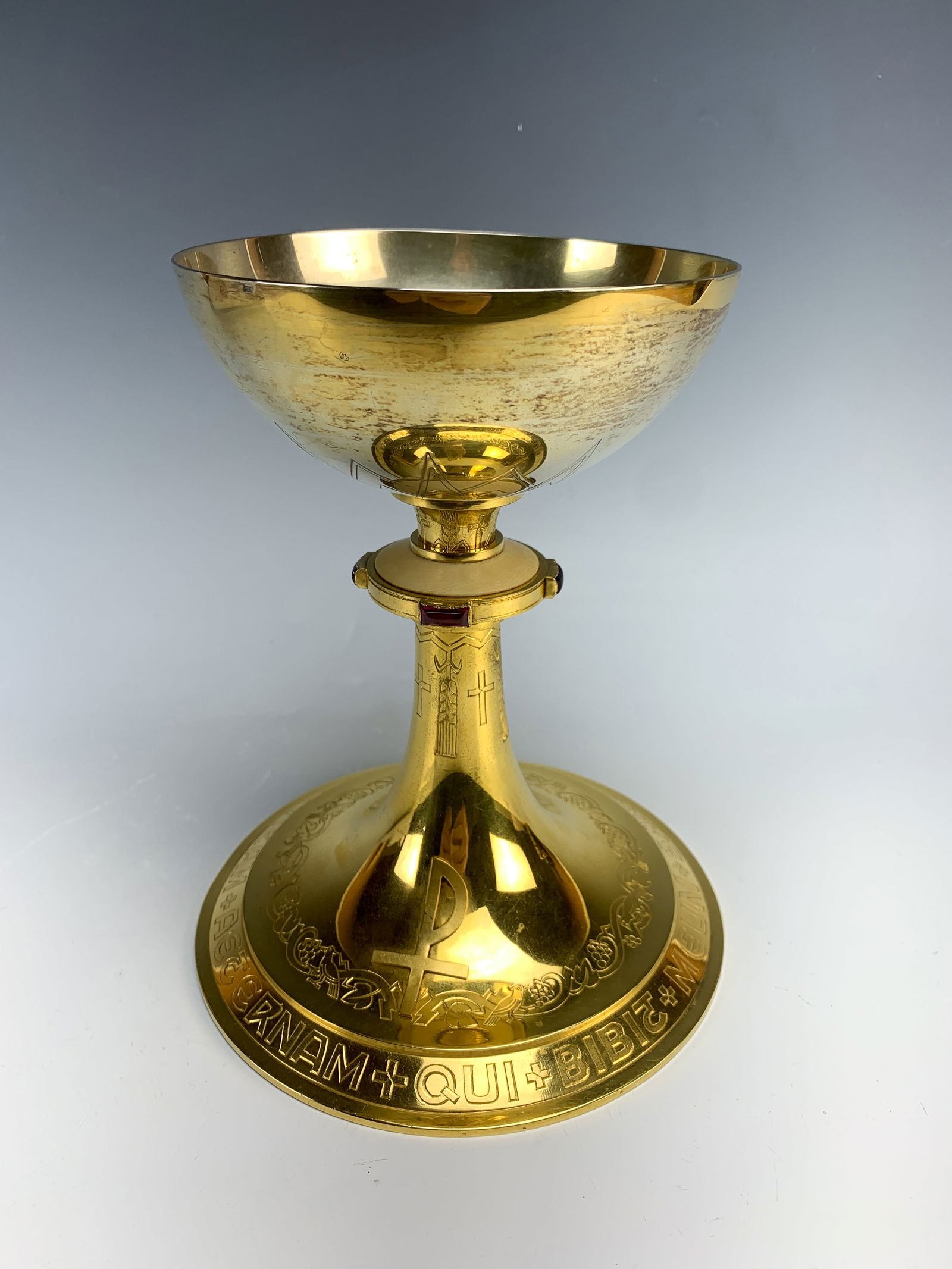 Ornate Neo Gothic Silver Chalice by Schwarzmann: Gold wash over 835 silver and made by Schwarzmann Germany, inscribed on bottom with cross, the nodus is decorated with 2 rectangular rubies and 2 rectangular amethysts and a central circular bone inse