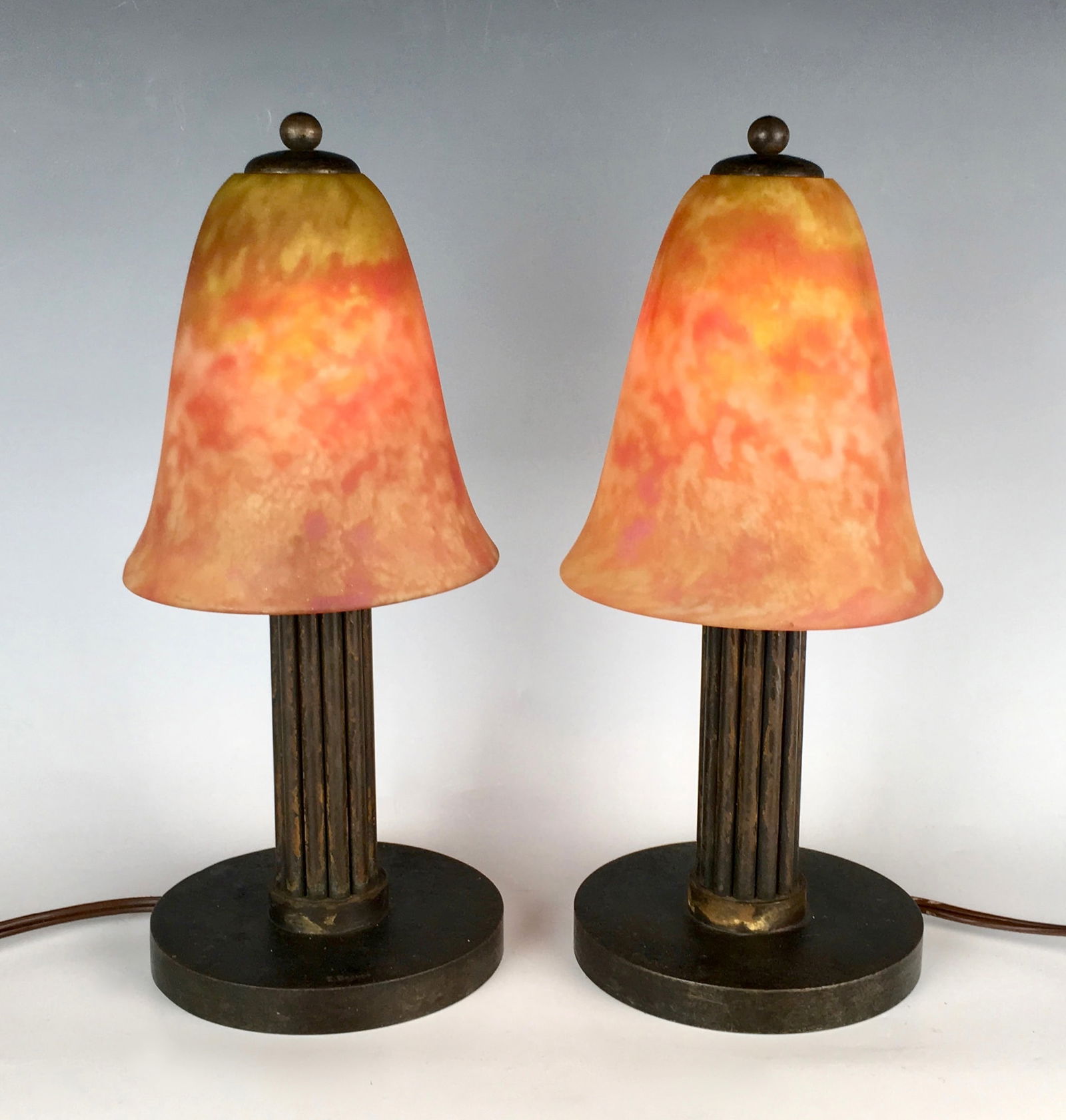 Edgar Brandt & Daum Nancy Pair Art Deco Lamps: Pair of Edgar Brandt (French 1880-1960) and Daum Nancy art deco boudoir lamps, wrought iron bases signed "E. Brandt" and orange marmoreal art glass shades signed "Daum Nancy”, very good conditio