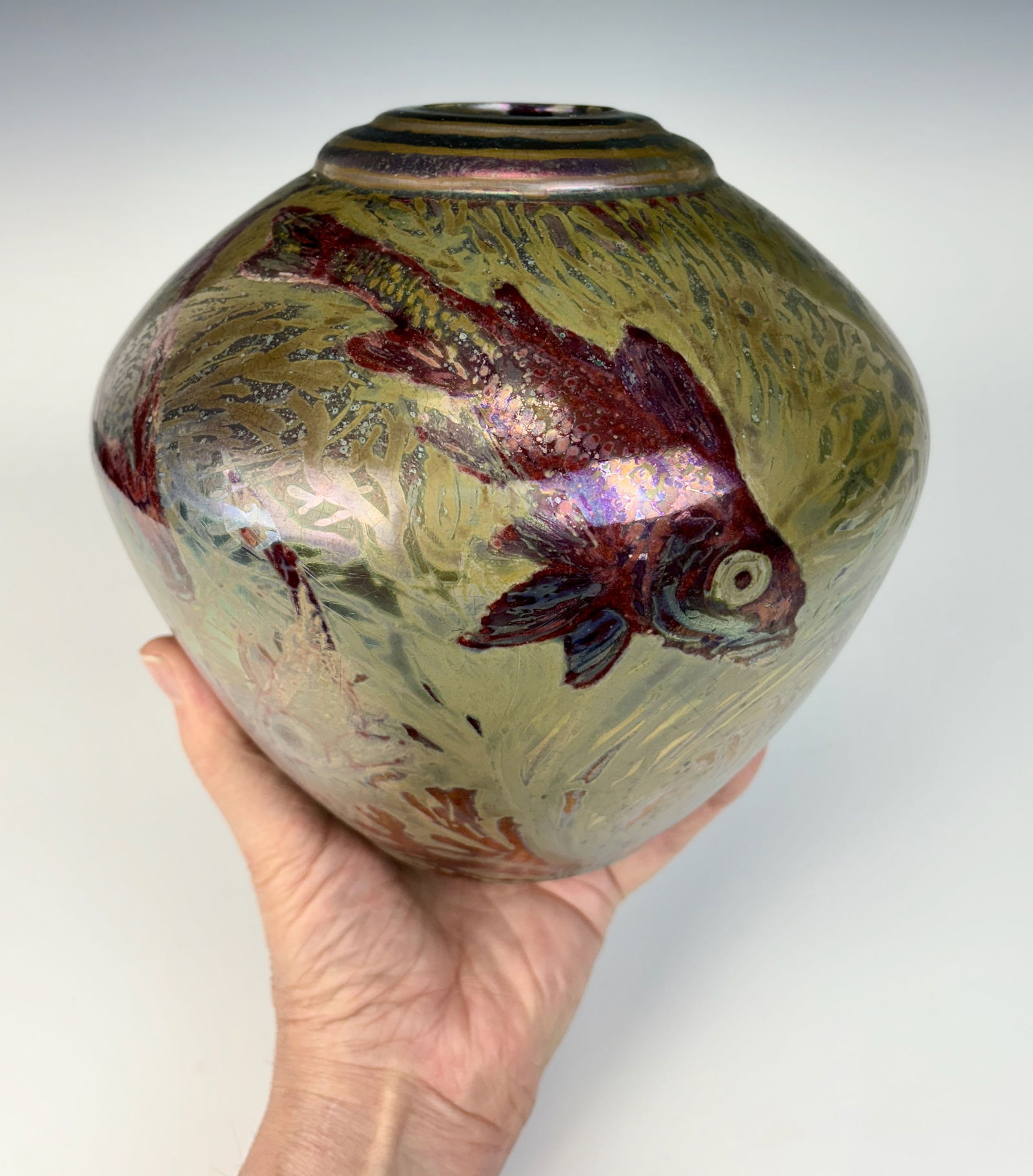 Rare Clement Massier Swimming Fish in Seaweed Vase: Clement Massier (France 1845-1917) Rare iridescent ceramic vase with fish swimming amid aquatic foliage design on a bulbous body with tapered stepped mouth opening. This is a beautiful vase with olive