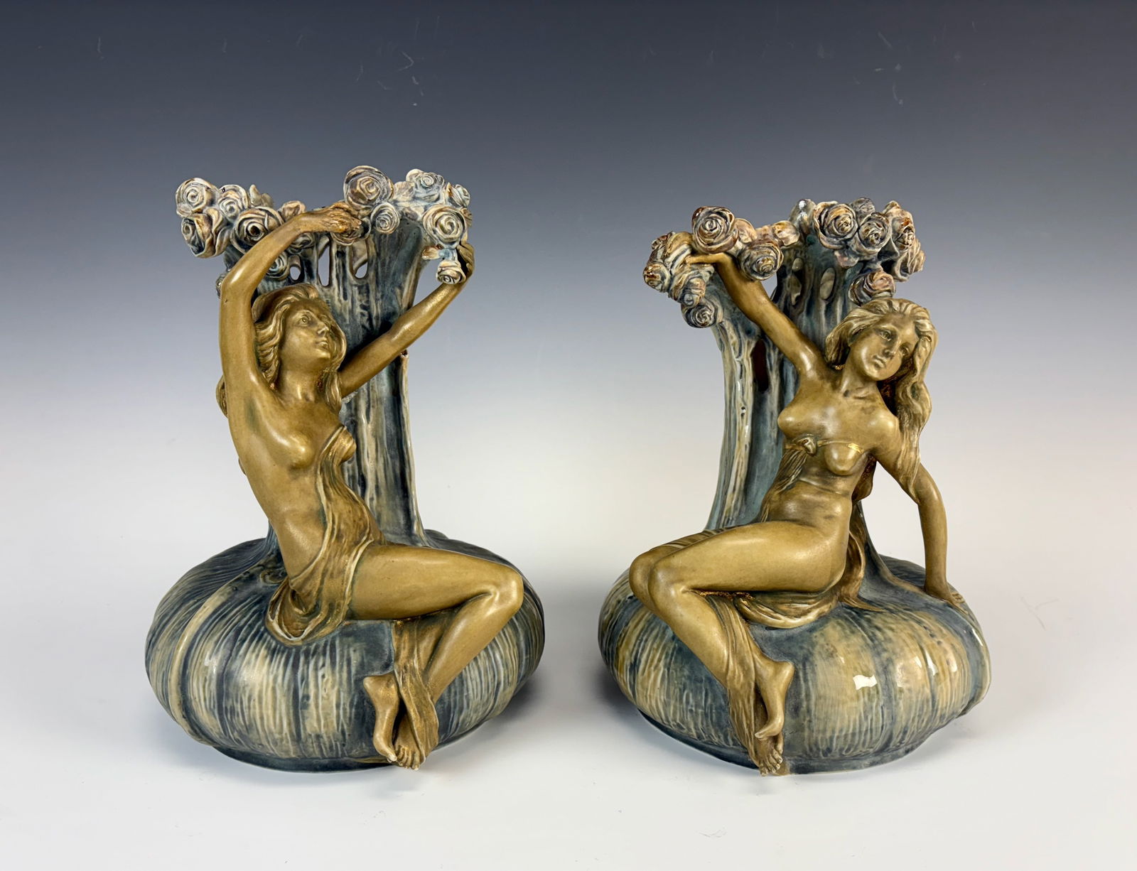 Pair Ernst Wahliss Semi Nude Art Nouveau Vases: Circa 1900, Ernst Wahliss (1837-1900), an Austrian porcelain designer and sculptor, wonderful and unusual earthenware pair (a left and a right) of art nouveau vases having scantilly clad maidens perch