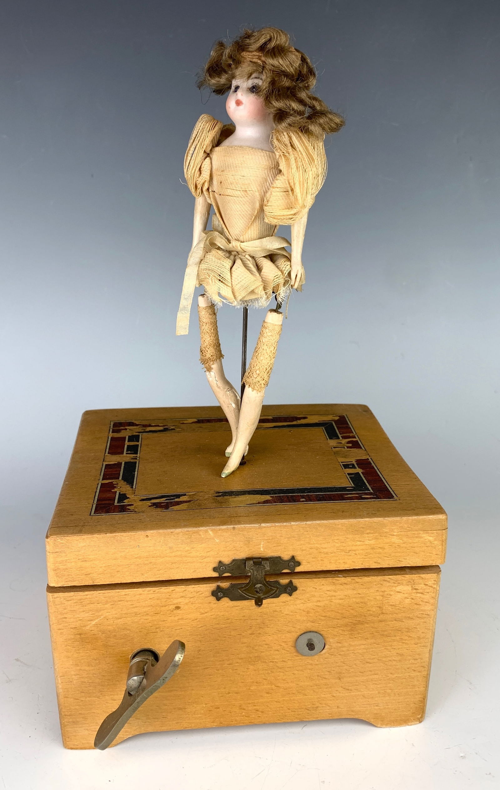 Giselle Dancing Doll on Musical Base: Bisque bust head, original clothes and wig, mounted atop a wood base, when turned on she dances and turns, dress missing, speed may need adjustment, normal wear commensurate with age, 10.5" height. Or