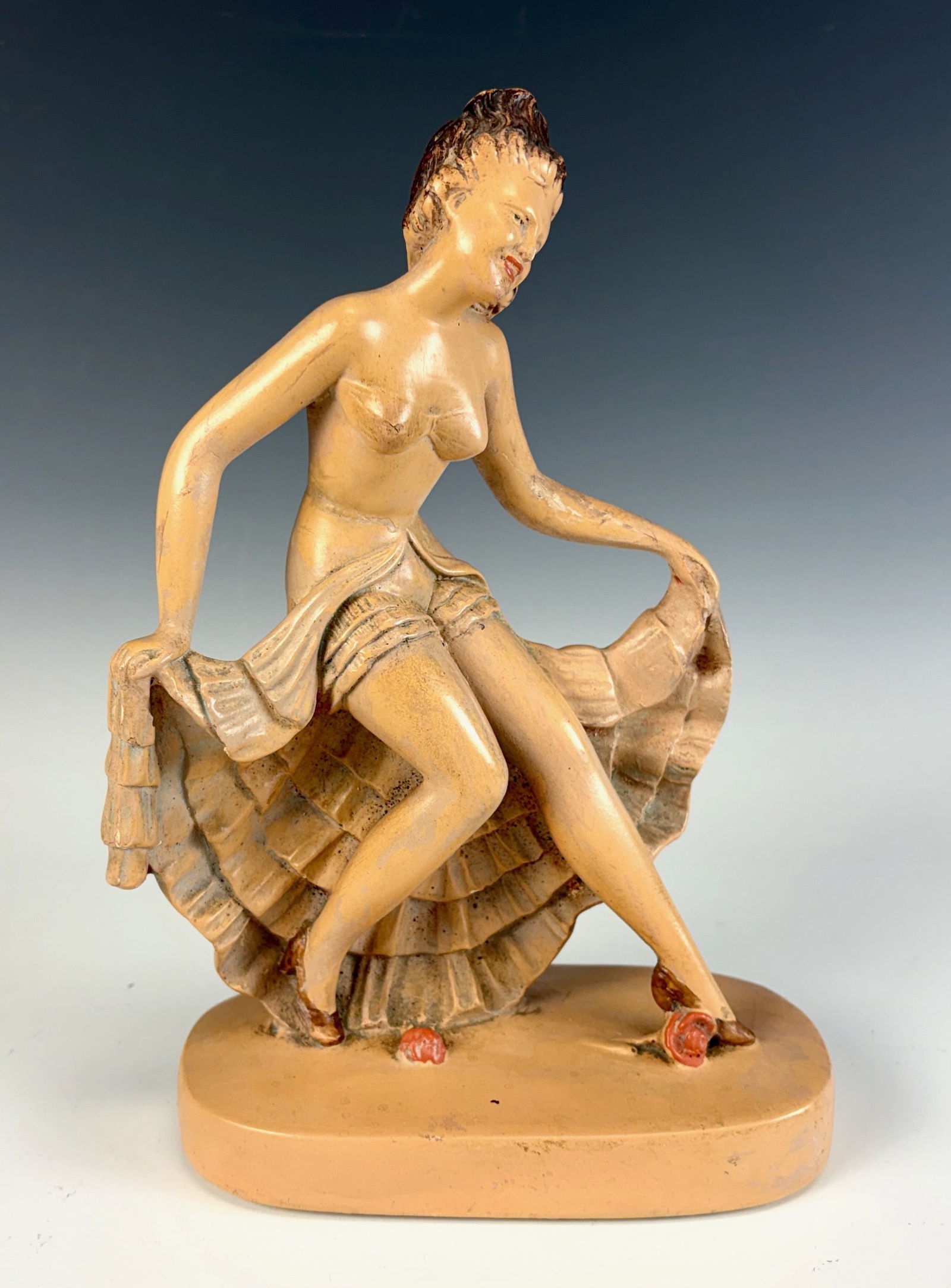 Art Deco Dancing Lady Figurine: An Art Deco figurine featuring a dancing lady holding her skirt made in Germany. 10” tall × 7” wide. In excellent condition.