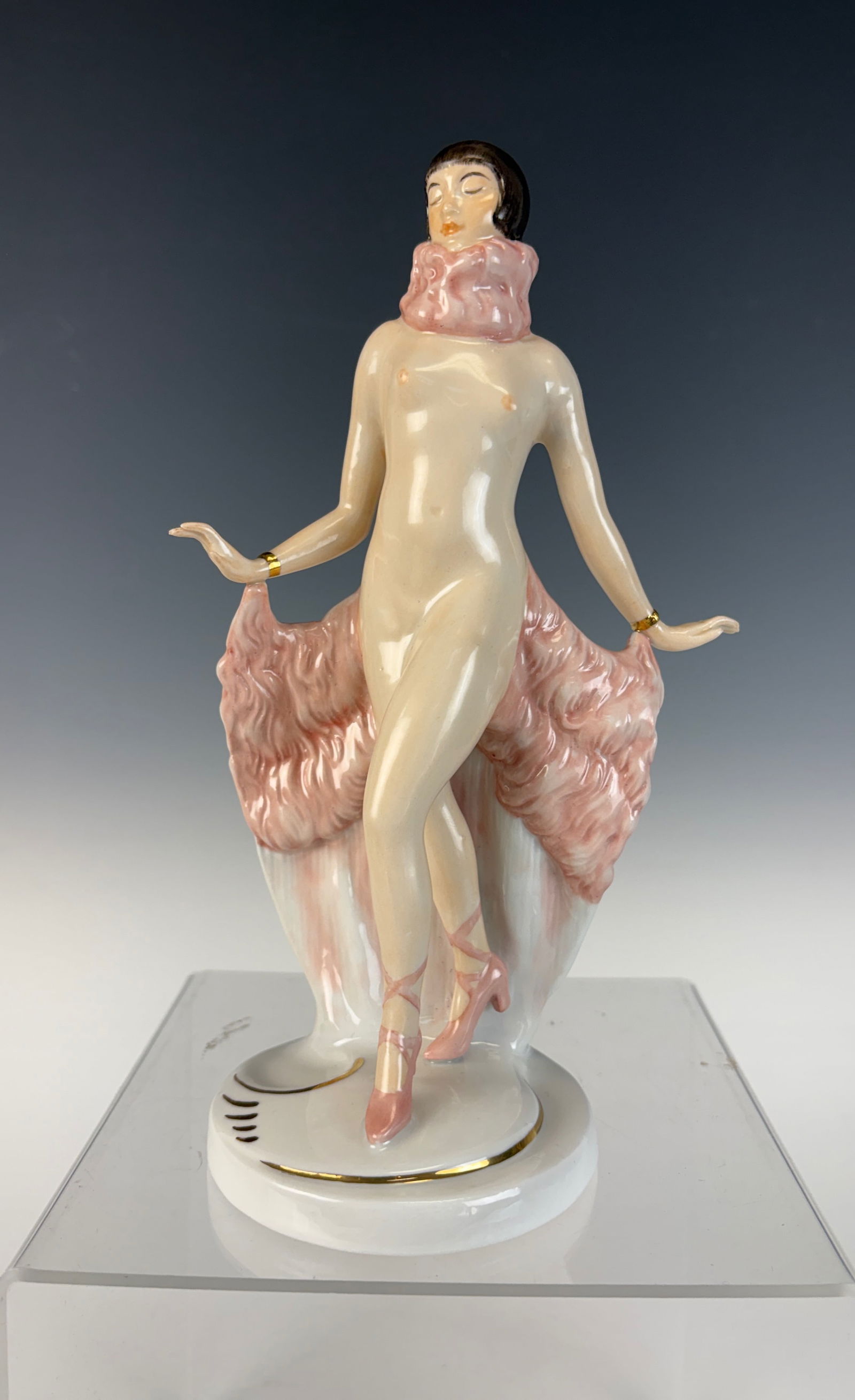 Fraureuth Nude Art Deco Dancer Figurine: A fine porcelain Art Deco figurine depicting a nude dancer draped with a pink feather shawl, signed on the bottom Fraureuth. 8.75” tall. In excellent condition.
